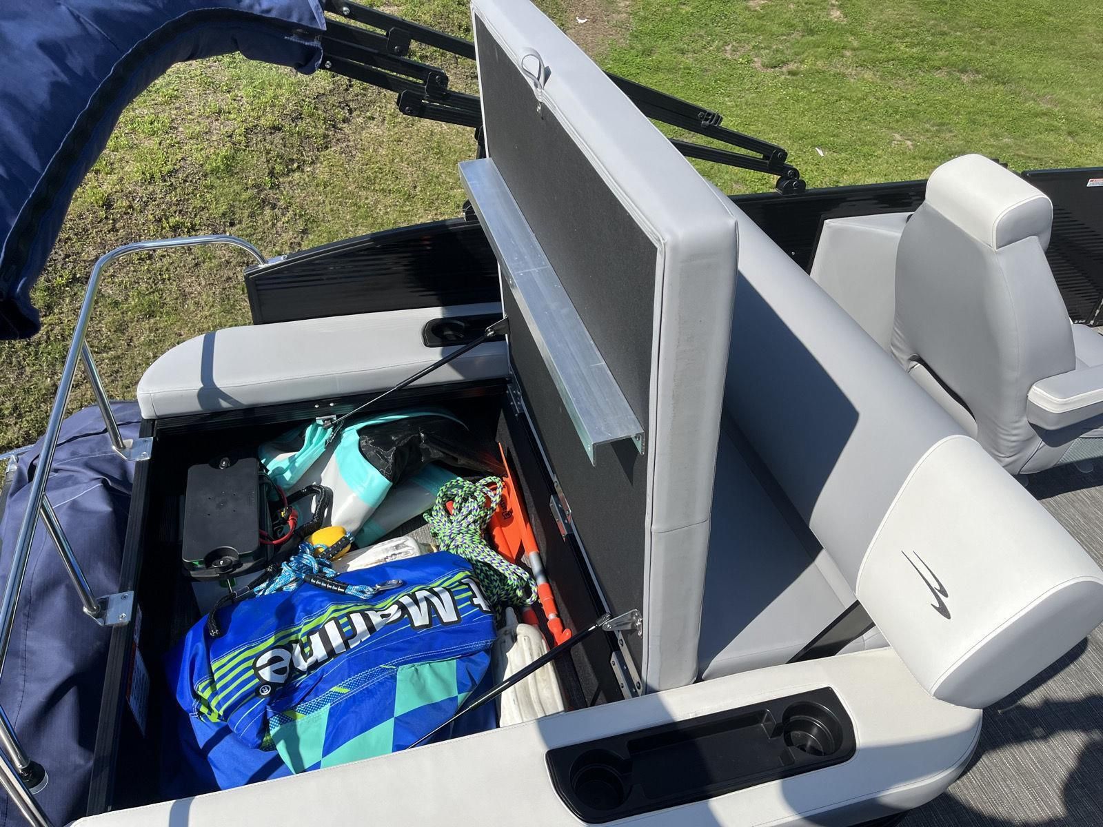 The image shows the storage area of a 2025 Bennington S20 boat, filled with watersports gear.