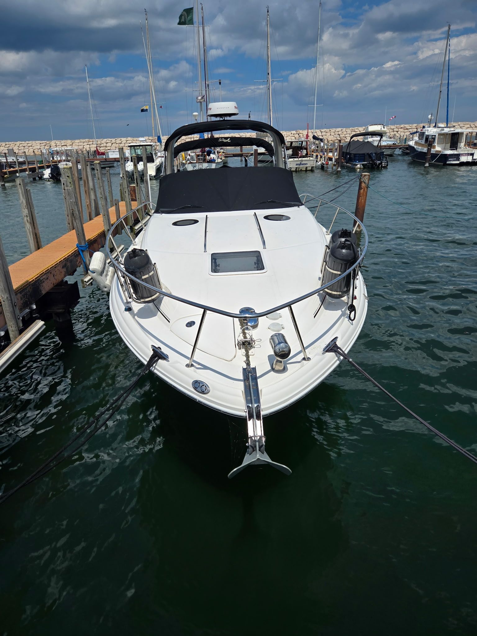 A 2006 Sea Ray 300 Sundancer is docked on the water.