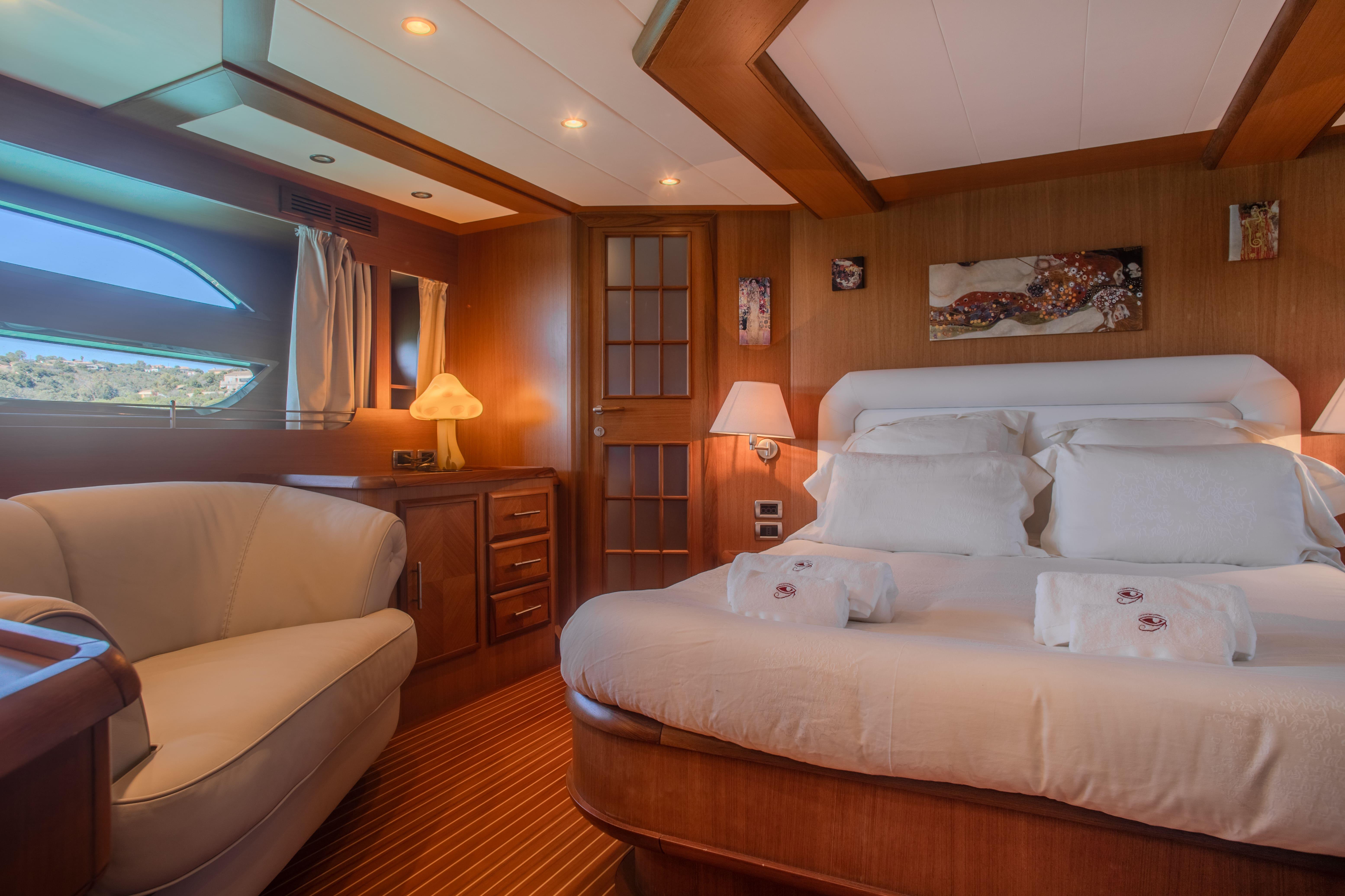 Luxurious cabin interior of 2005 Mochi Craft 74' Dolphin yacht with elegant wood finishes.