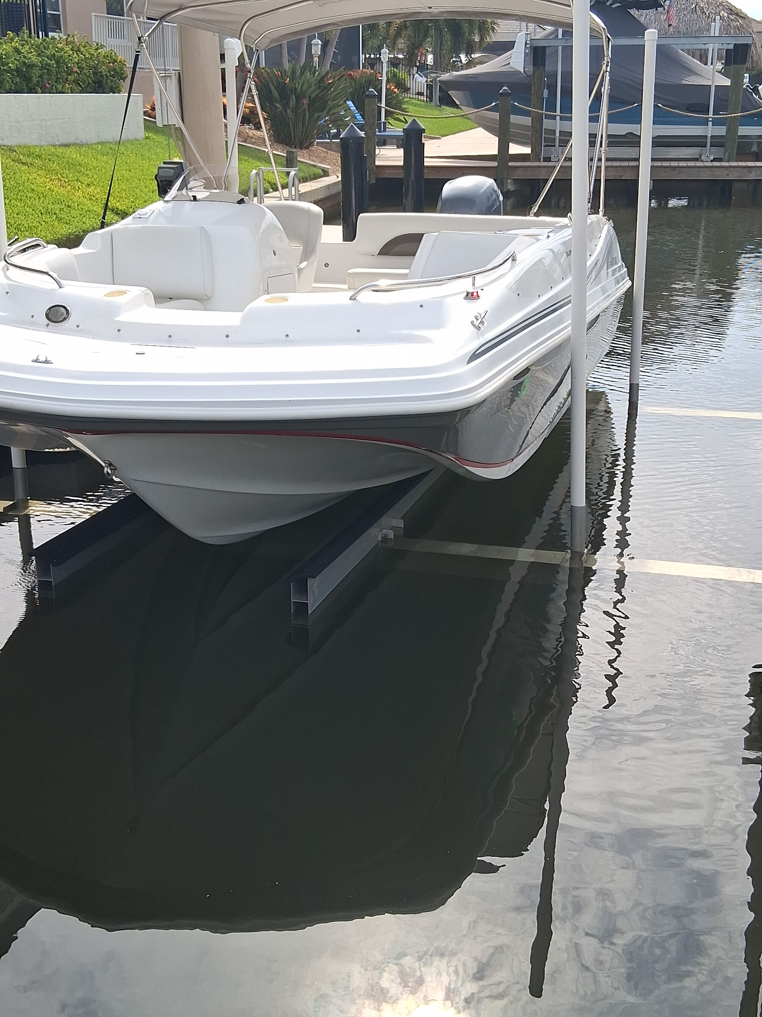 2013 Hurricane 188SD boat on a lift over water.