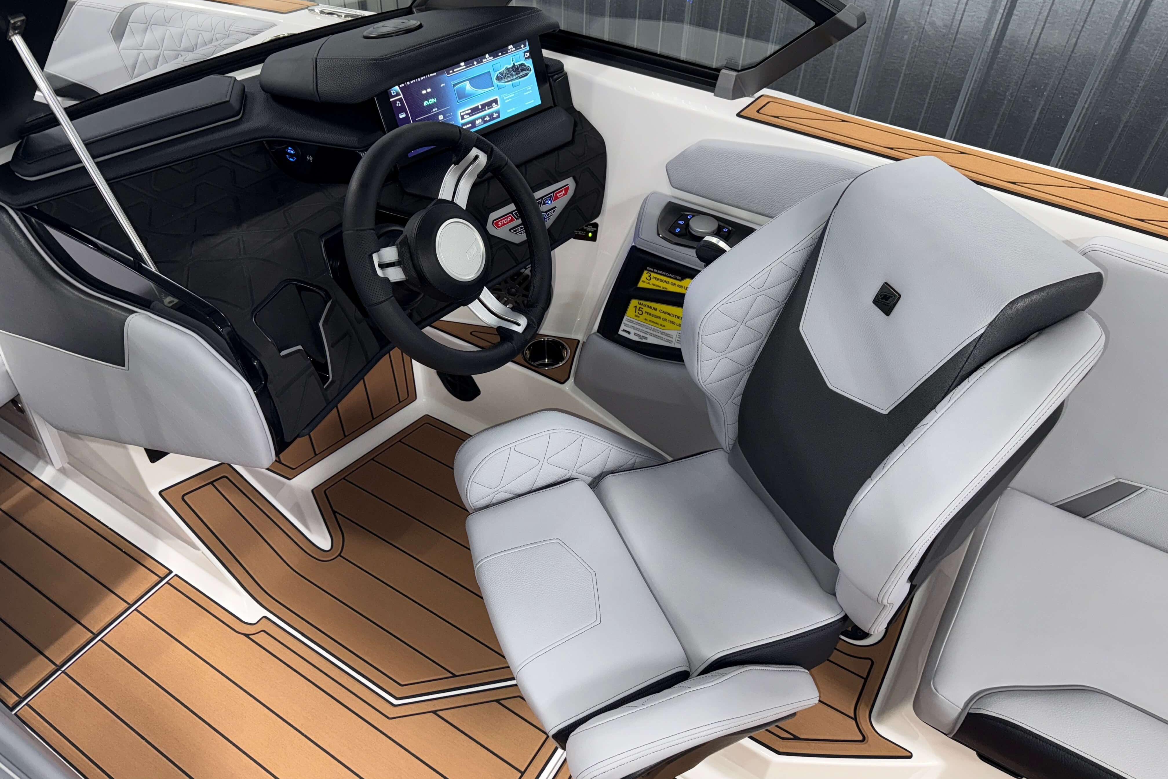 2026 Nautique Super Air Nautique GS22 cockpit with modern steering and luxurious seating.