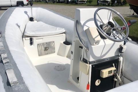 1995 Novurania Tender boat with steering wheel and seating area.