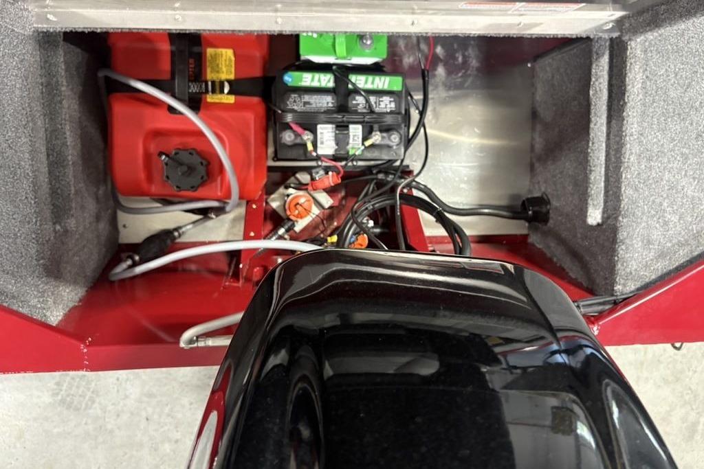 Interior view of a 2026 Tracker Bass Tracker Classic XL boat showing battery and fuel tank setup.