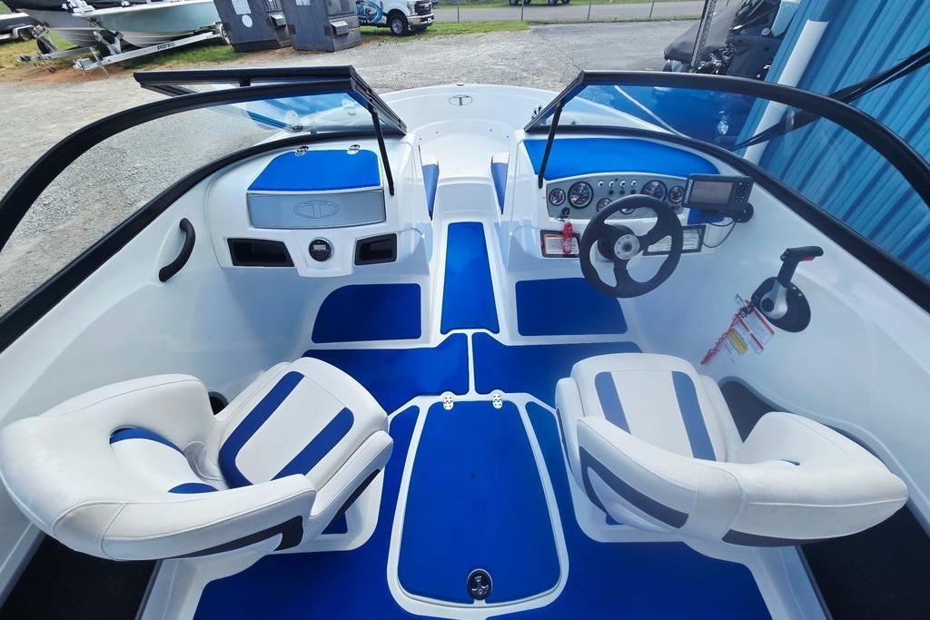 Interior of a 2018 Tahoe 450 TS boat with blue and white seating and dashboard.
