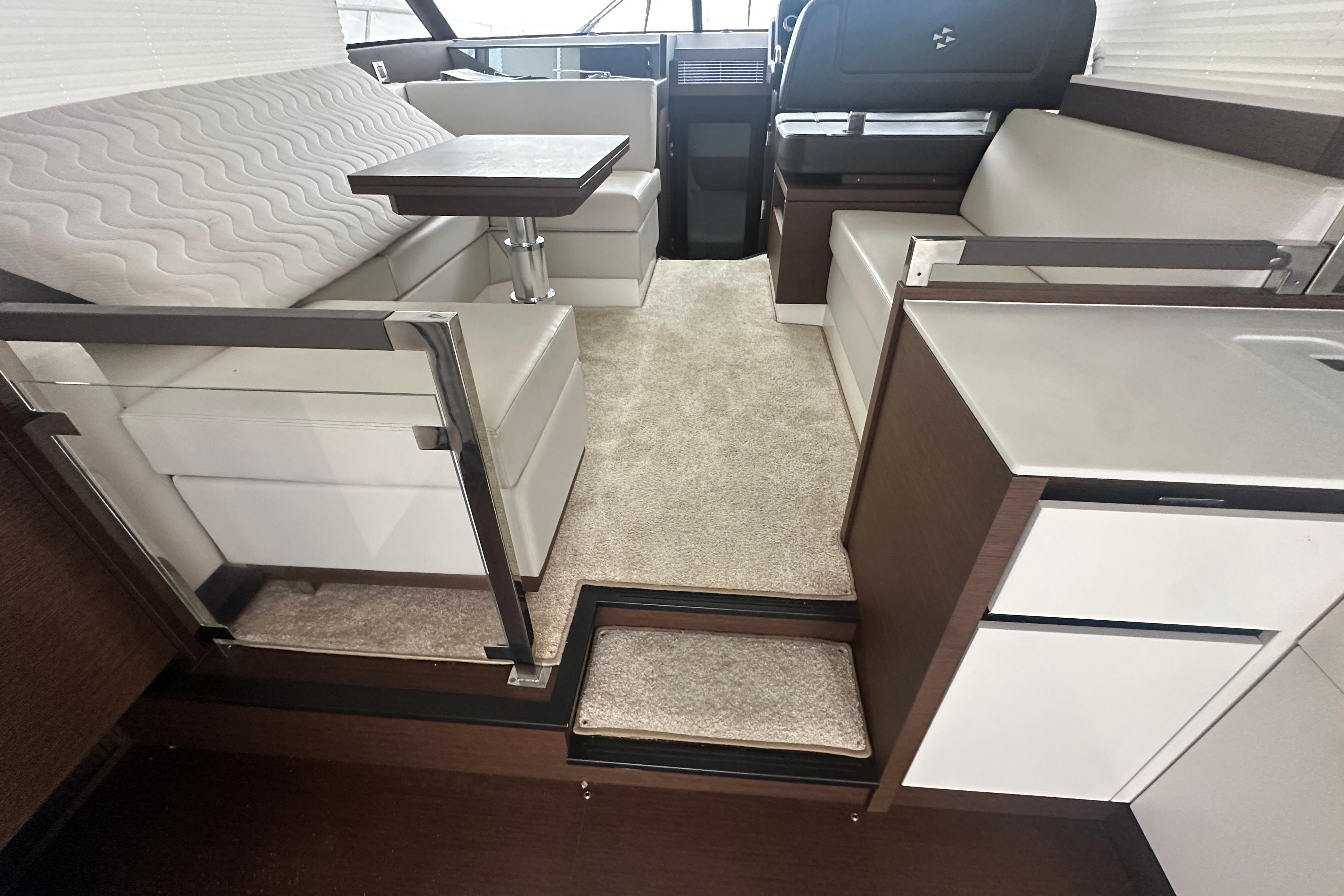 Interior of 2020 Prestige 460 yacht with modern seating and table arrangement.
