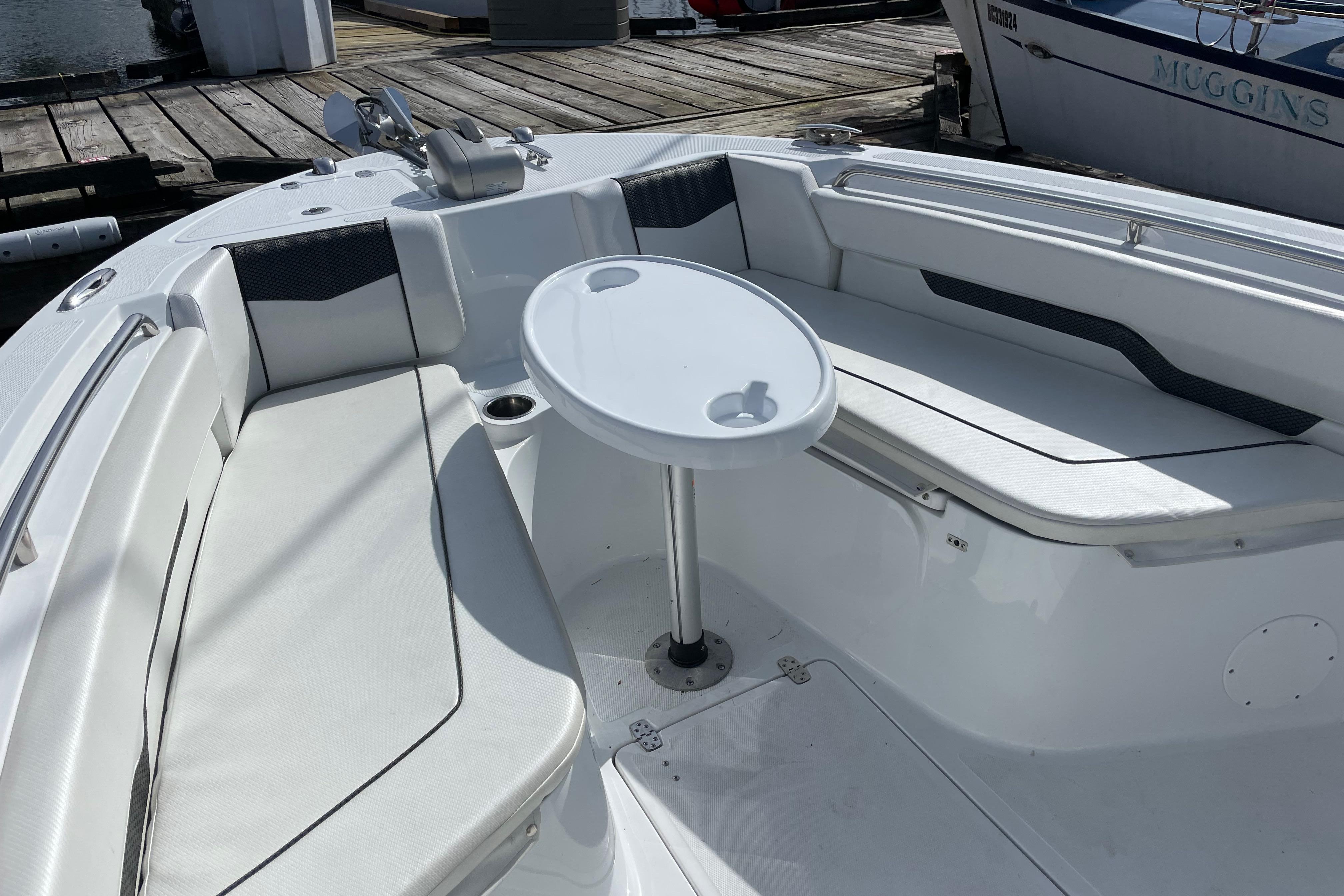 2023 Wellcraft 222 Fisherman boat interior with seating and table.