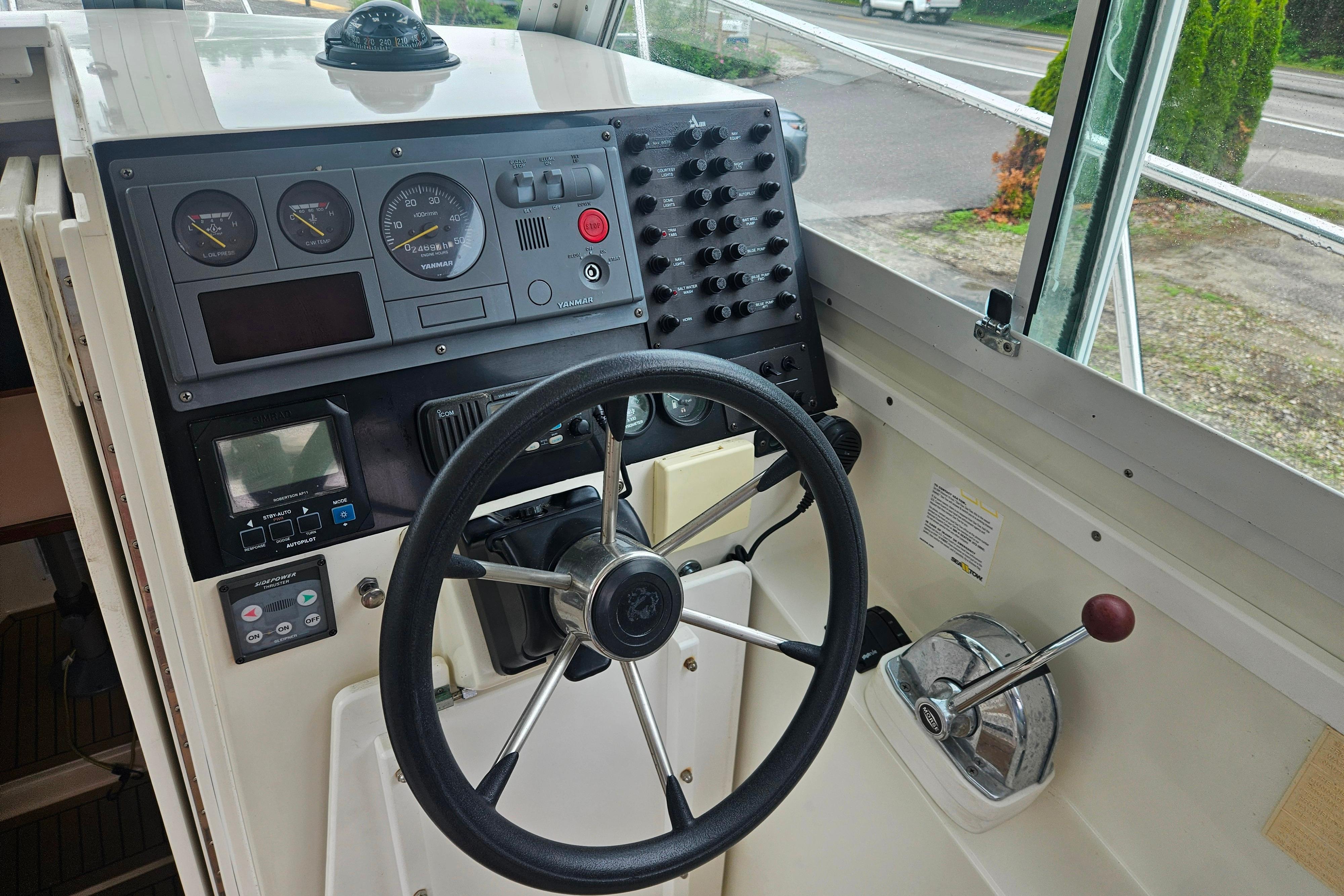 1999 Albin 28 Tournament Express helm with steering wheel, gauges, and controls.