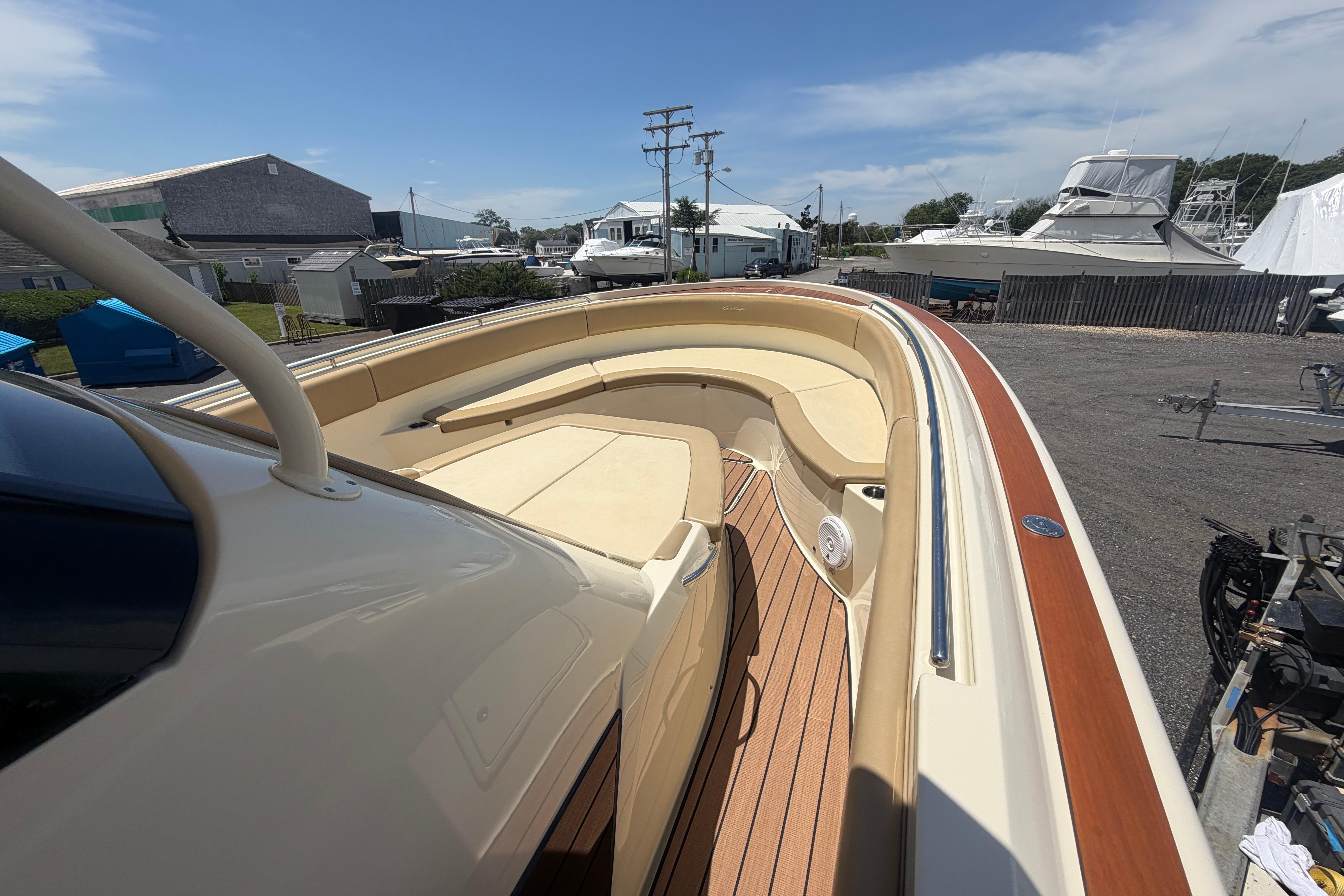 2017 Chris-Craft Catalina 34 boat with elegant seating and teak flooring in a marina setting.