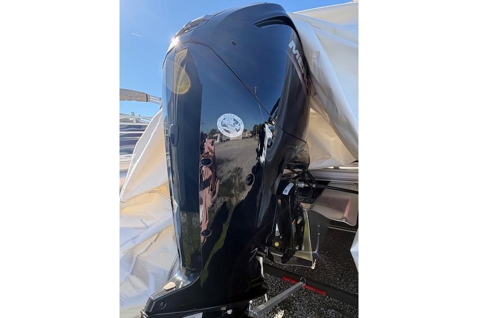 2025 Sun Tracker Party Barge 18 DLX with Mercury outboard engine, partially covered.