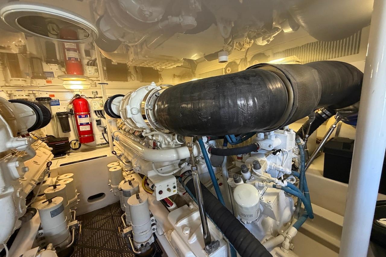 Engine room of a 2012 Viking 50 Convertible yacht, showcasing detailed machinery and equipment.