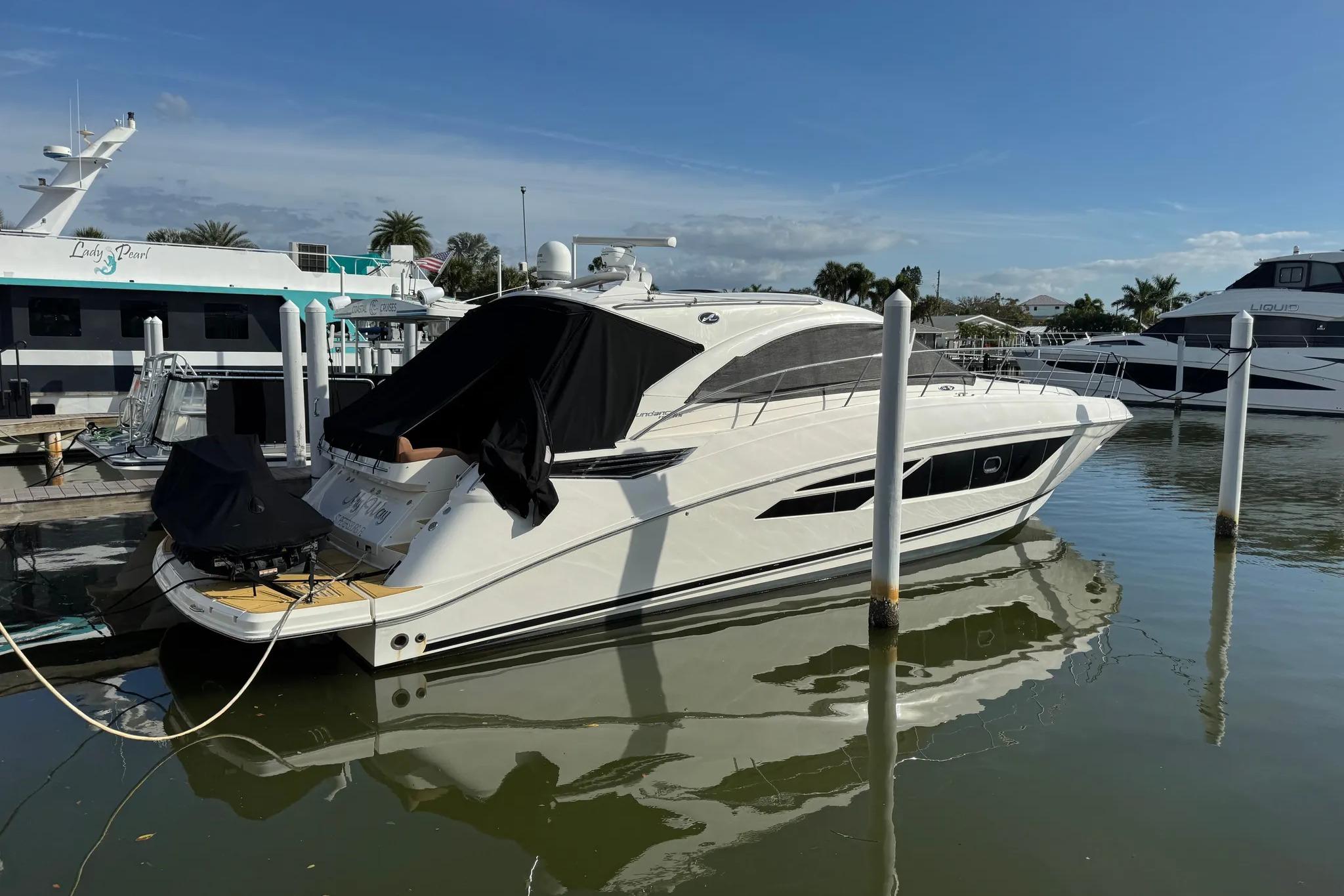 2016 Sea Ray Sundancer 510 yacht docked at marina under clear blue sky.