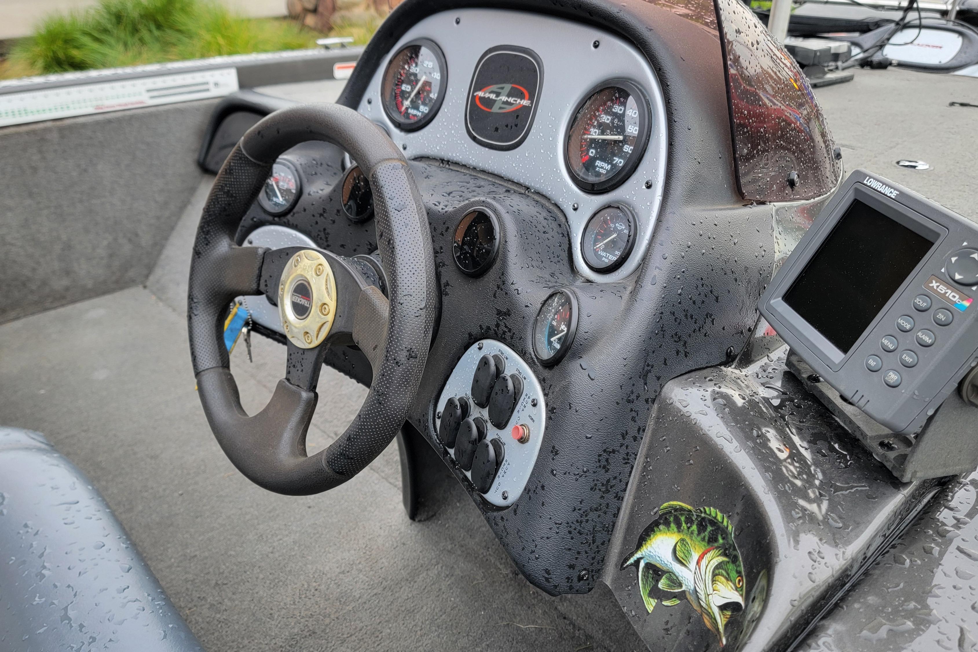 2006 Tracker Avalanche 18 SC boat dashboard with steering wheel and fish finder.