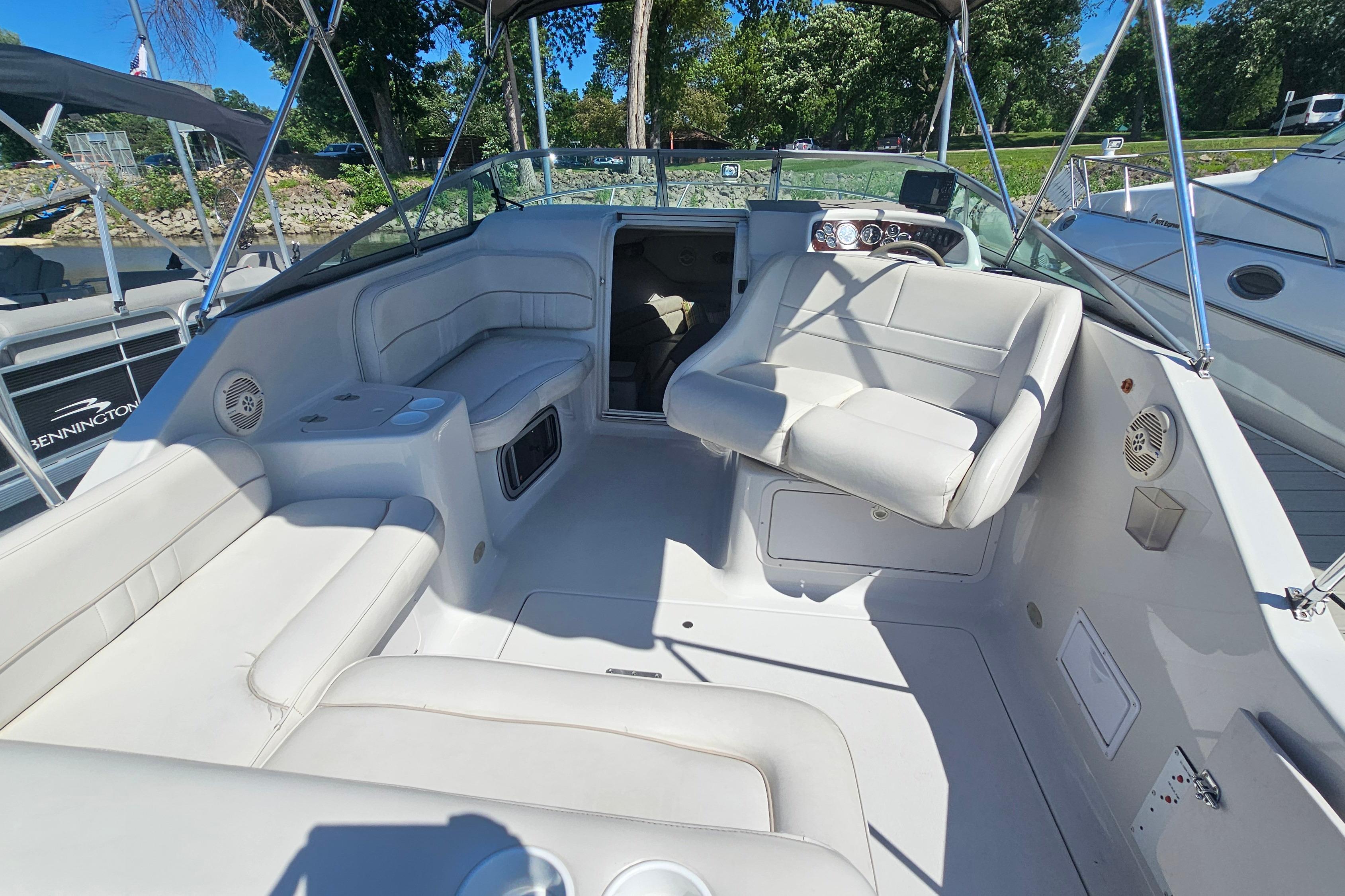 2000 Crownline 242 CR boat interior with white seating and steering area.