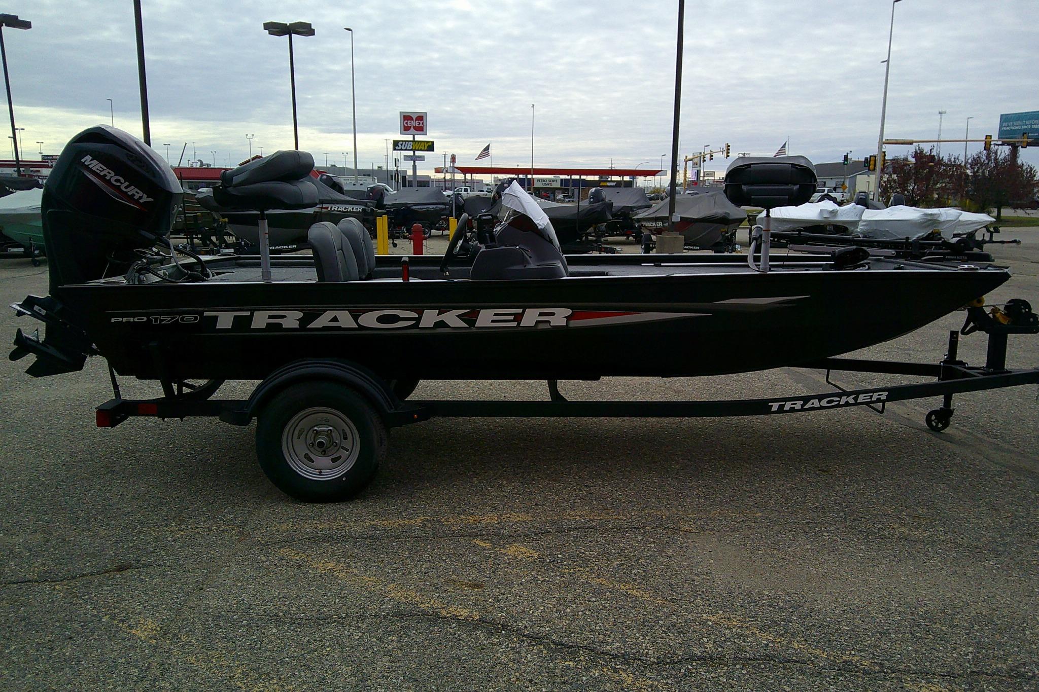 2025 Tracker Pro 170 boat on trailer in parking lot, overcast sky.