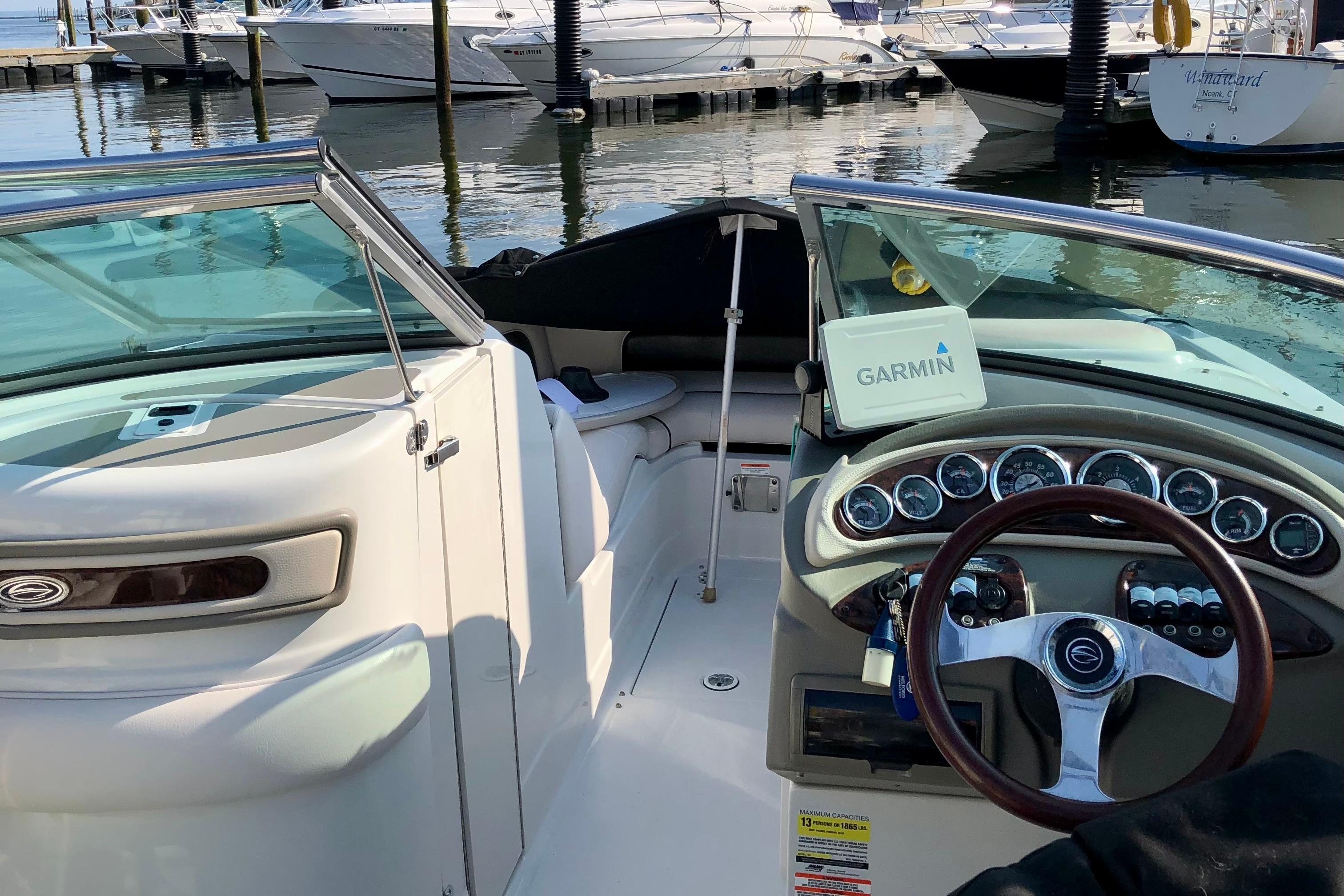 2013 Crownline Eclipse E4 boat interior with Garmin navigation, docked at marina.