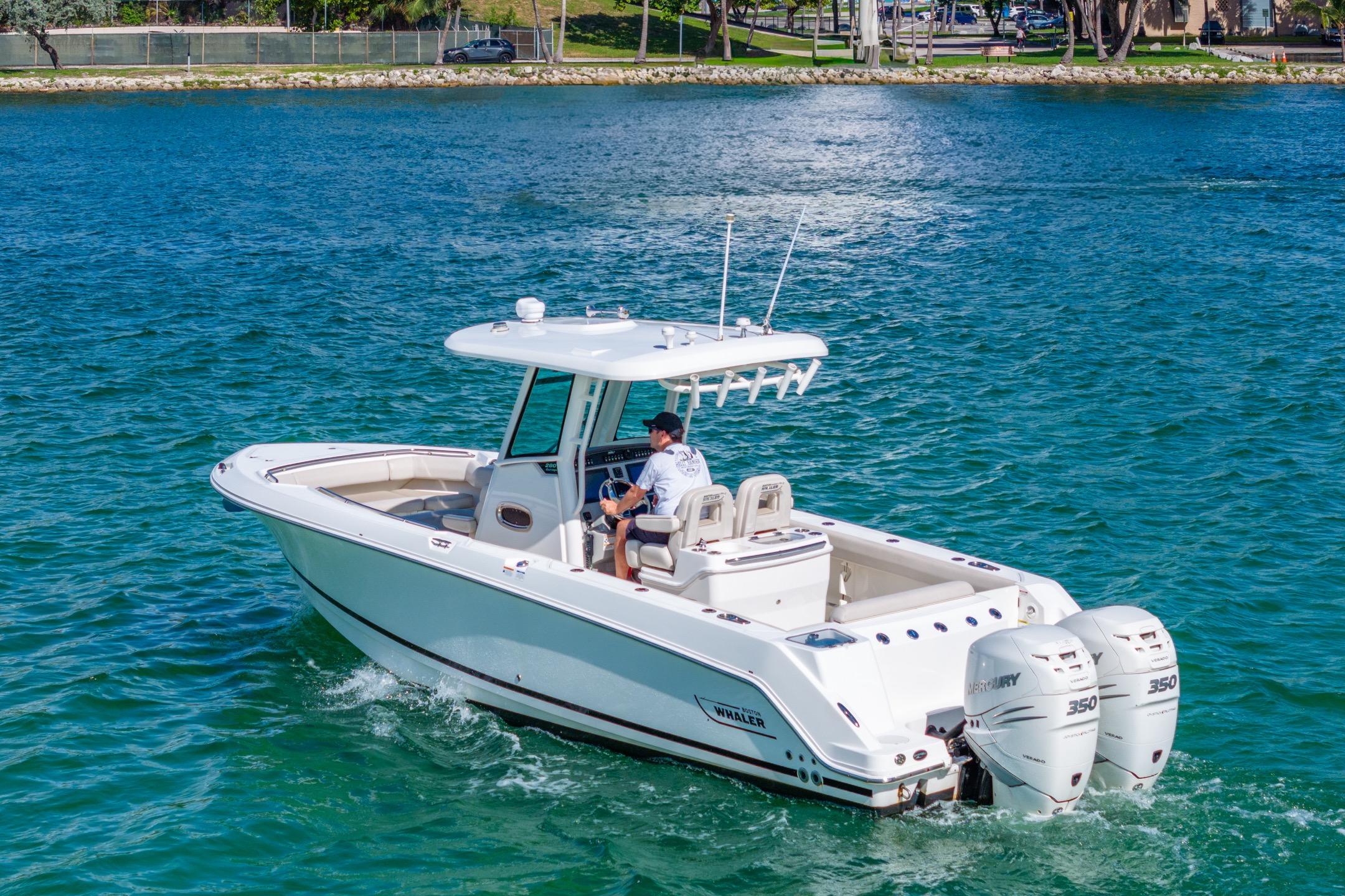 2016 Boston Whaler 280 Outrage boat cruising on clear blue water.