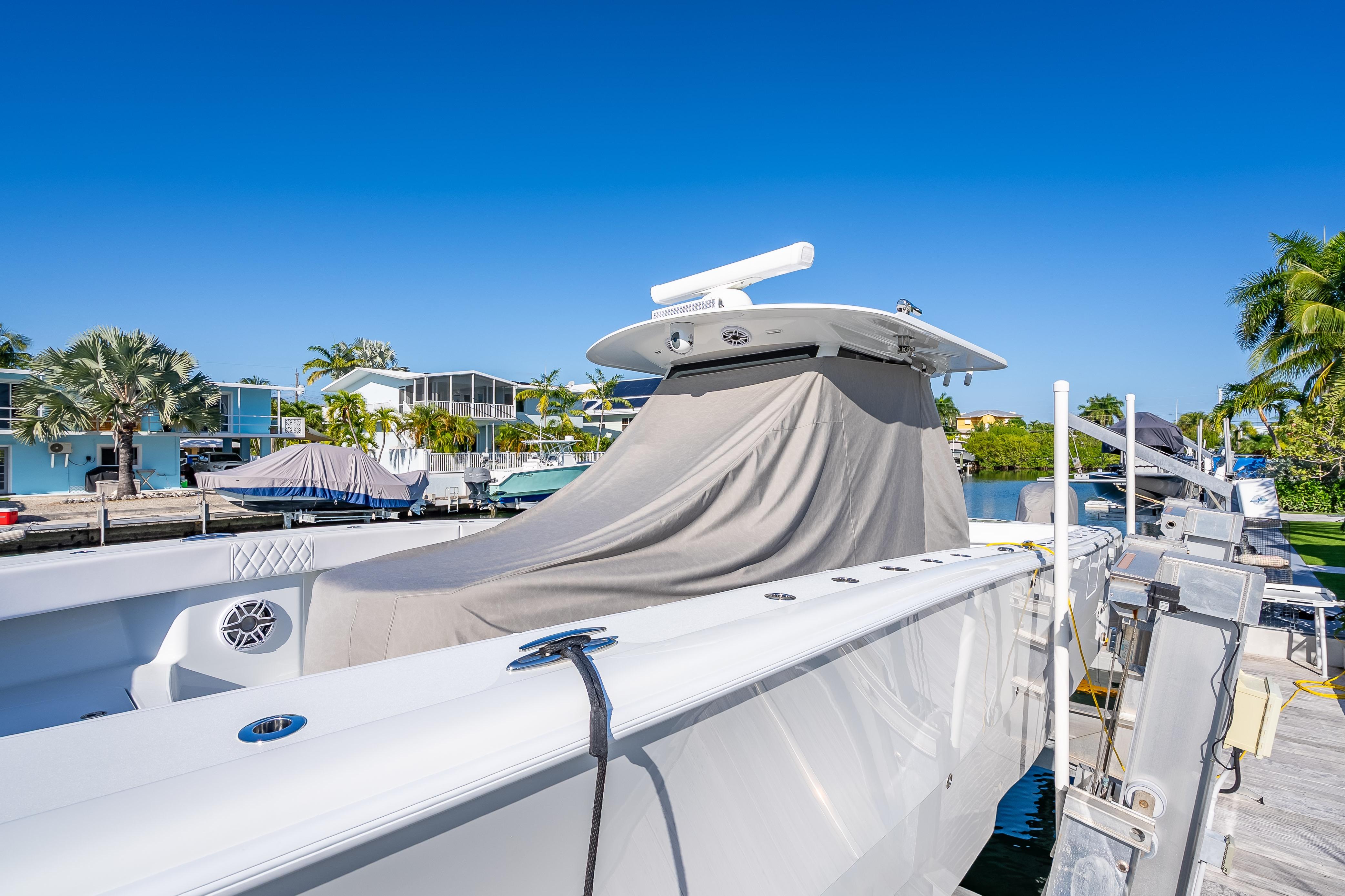 2026 Freeman 35 boat docked, covered, with clear blue sky and tropical surroundings.