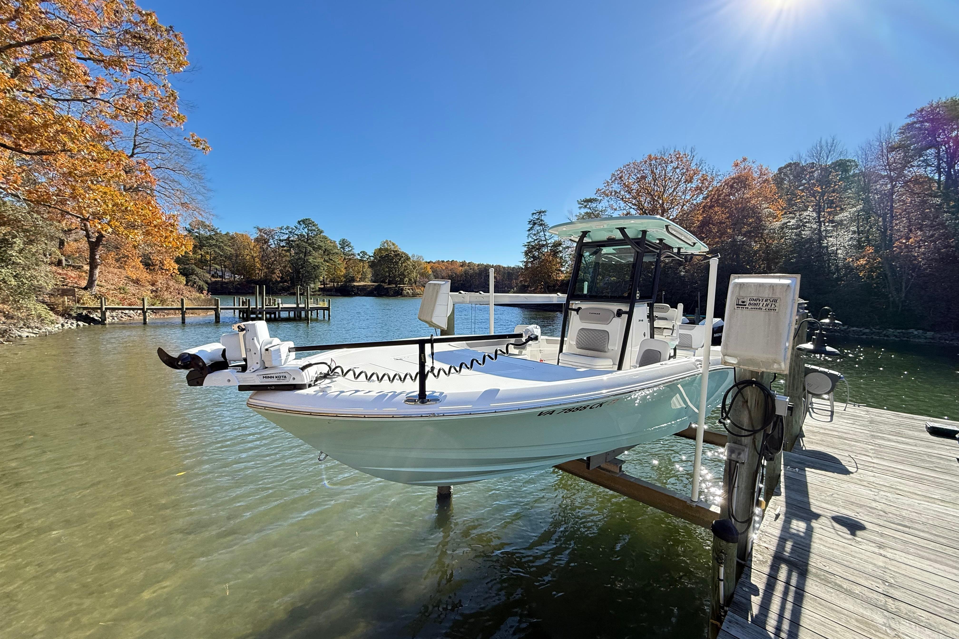 2023 Caymas 281 HB boat docked on a sunny autumn day by the lake.