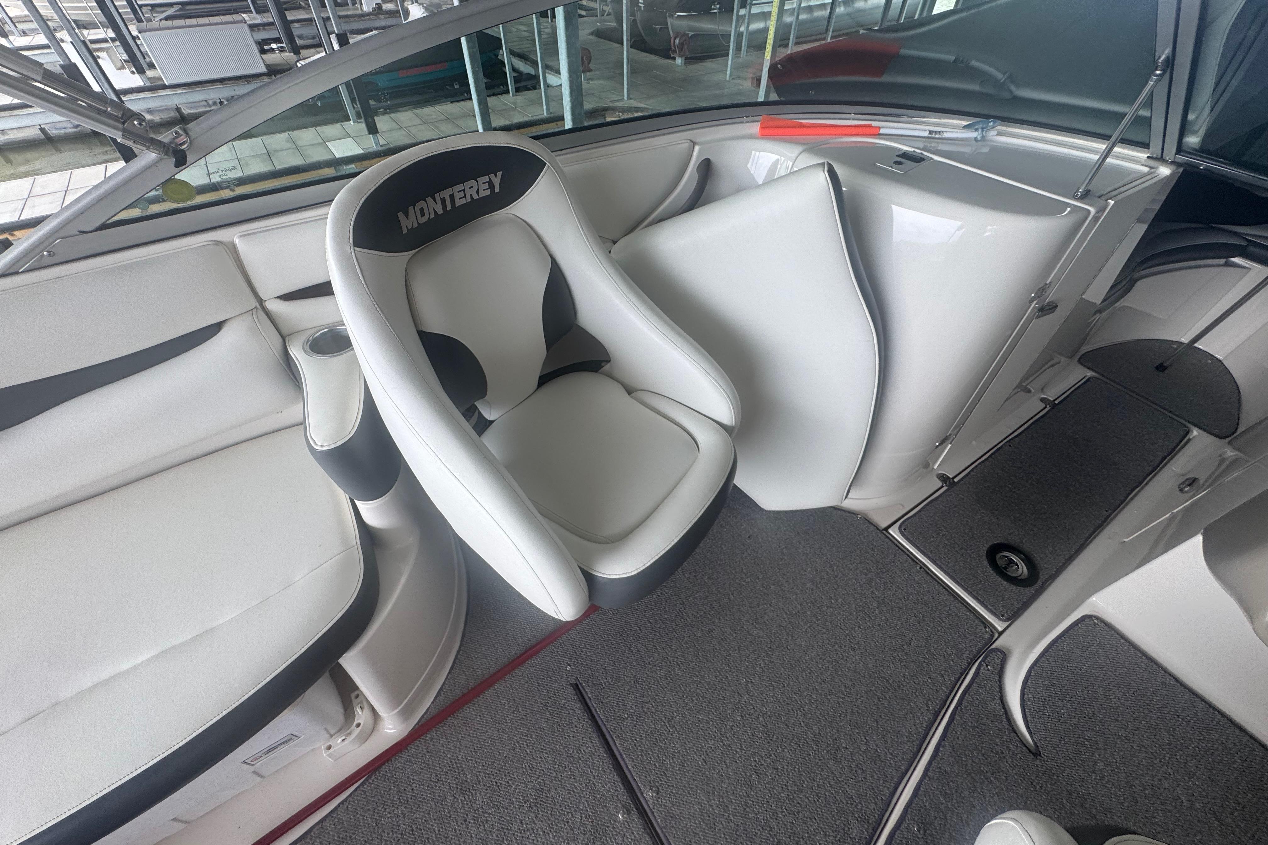 2005 Monterey 248LS Montura Bowrider interior with white seating and carpeted flooring.
