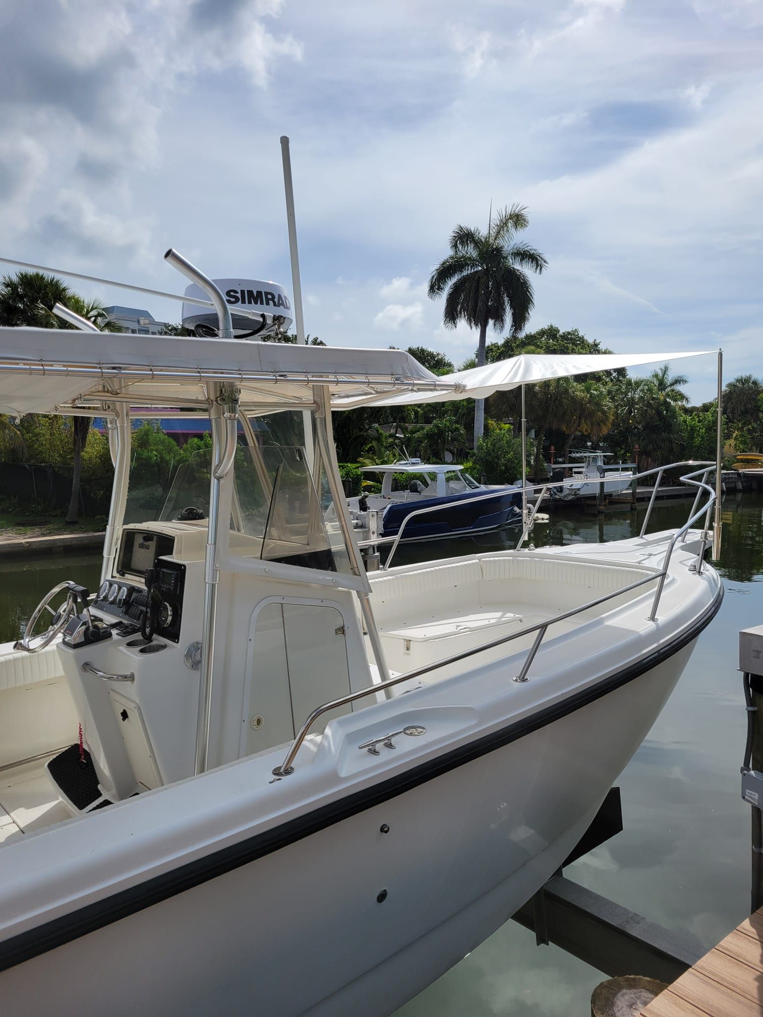 Boston Whaler 26 Outrage 2001 at dock, sunny day.
