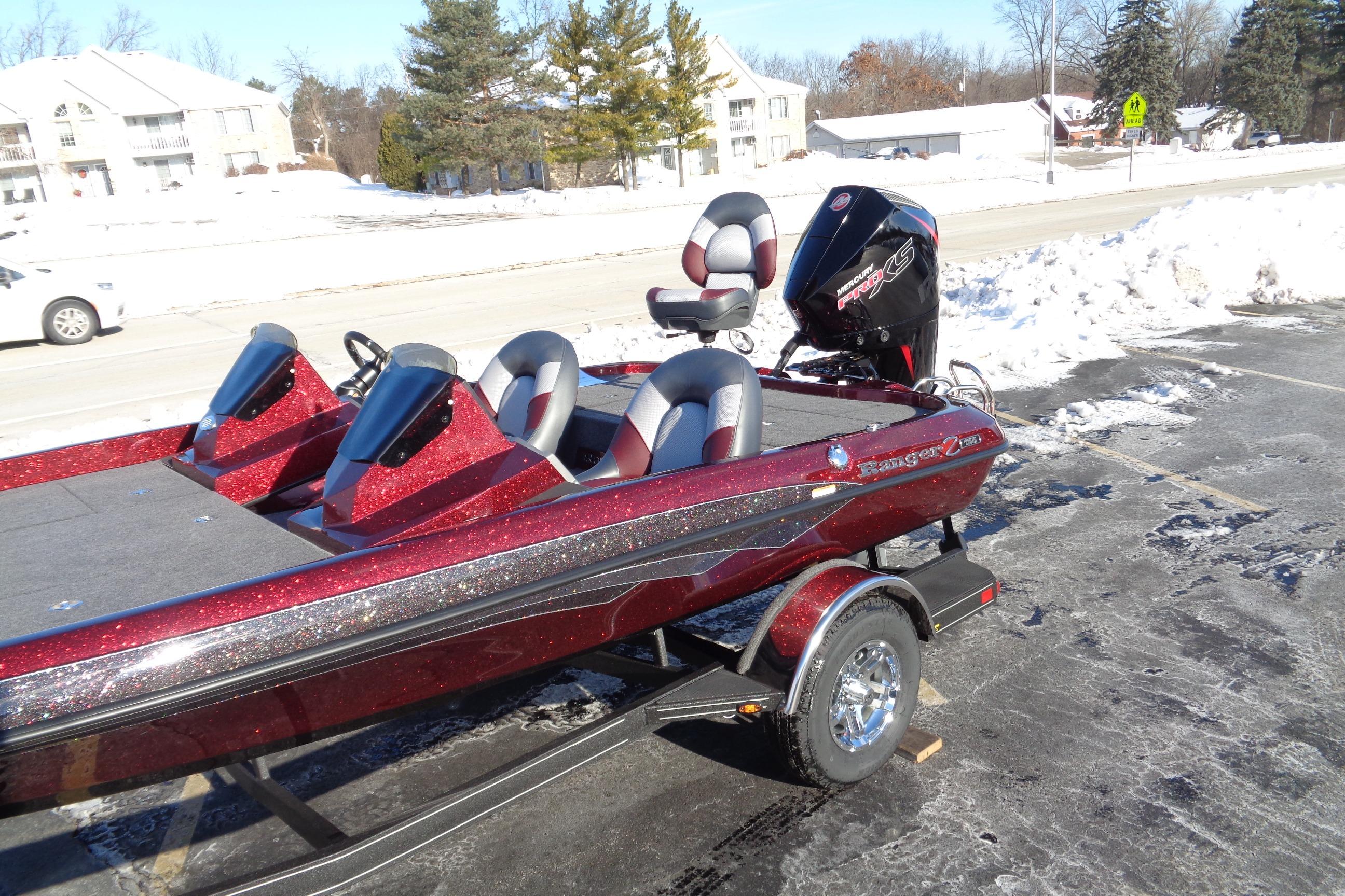2026 Ranger Z185 boat with red metallic finish parked on snowy pavement.