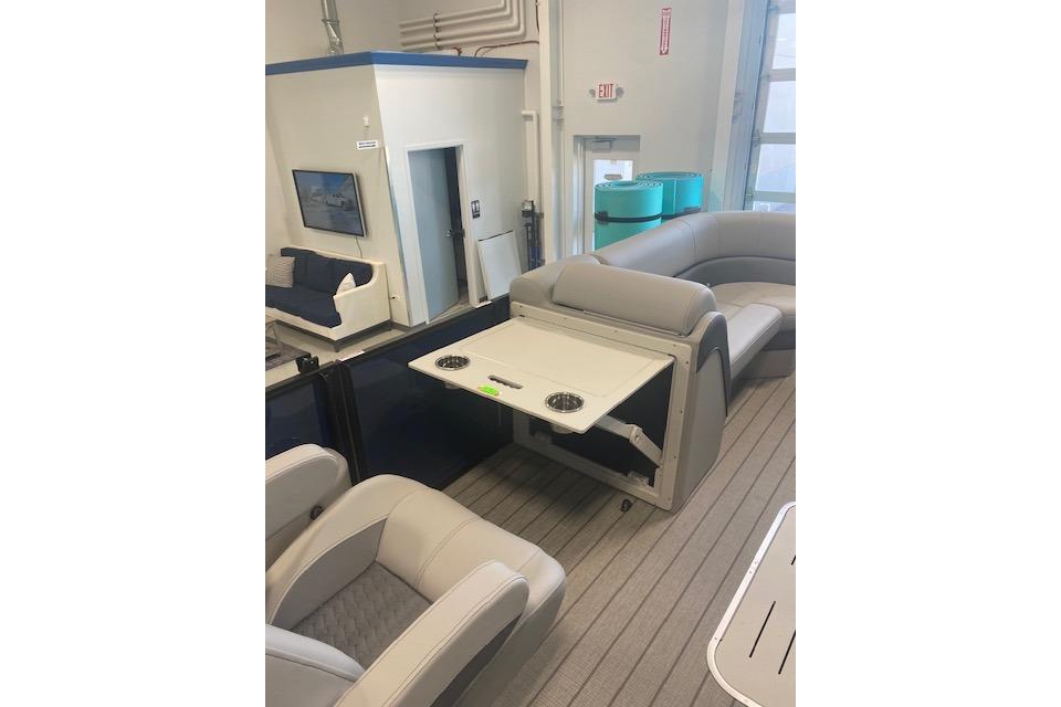 2026 Bentley Pontoons Elite 223 Swingback interior with luxurious seating and table setup.