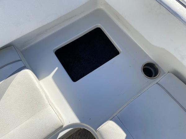2019 Caravelle 19 EBo Bowrider boat interior with storage compartment and cup holder.