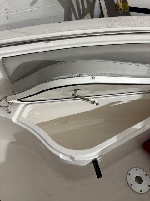 Open storage compartment on a 2022 Pursuit C 238 Center Console boat.