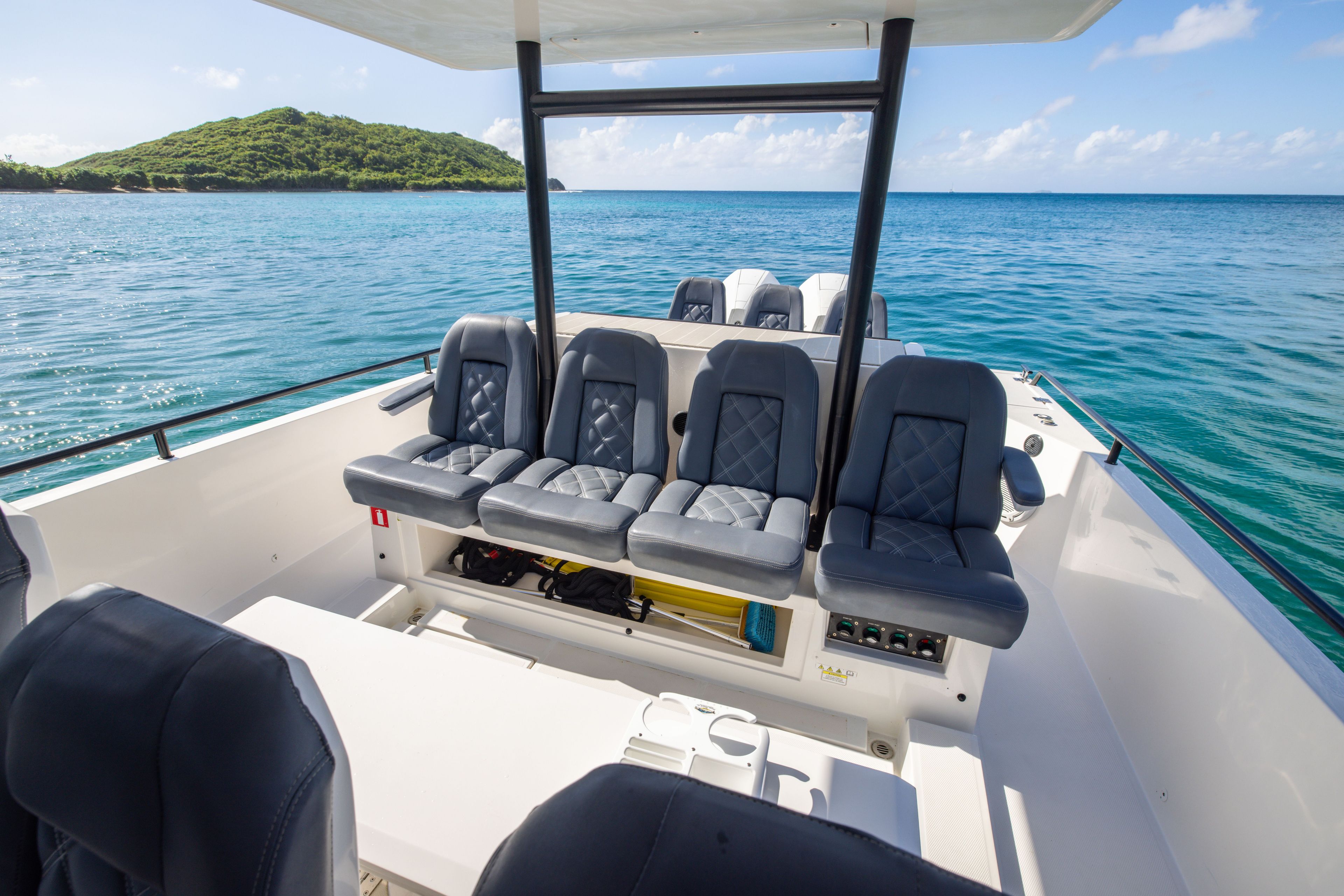 Axopar 37 SUN TOP 2020 on calm water with an island in the background.