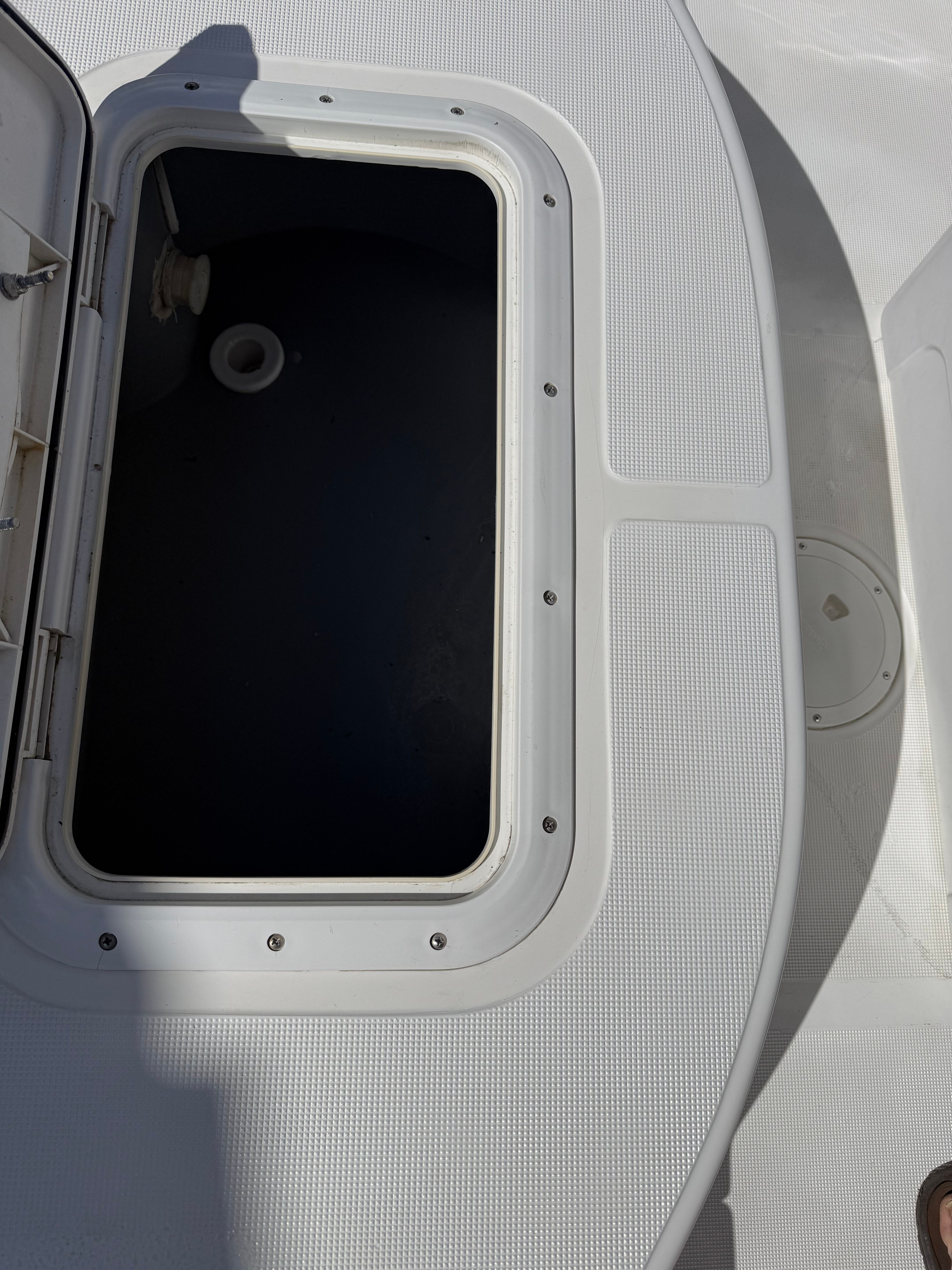 Open storage compartment on a 1998 Robalo 2100 Bay Hunter boat.