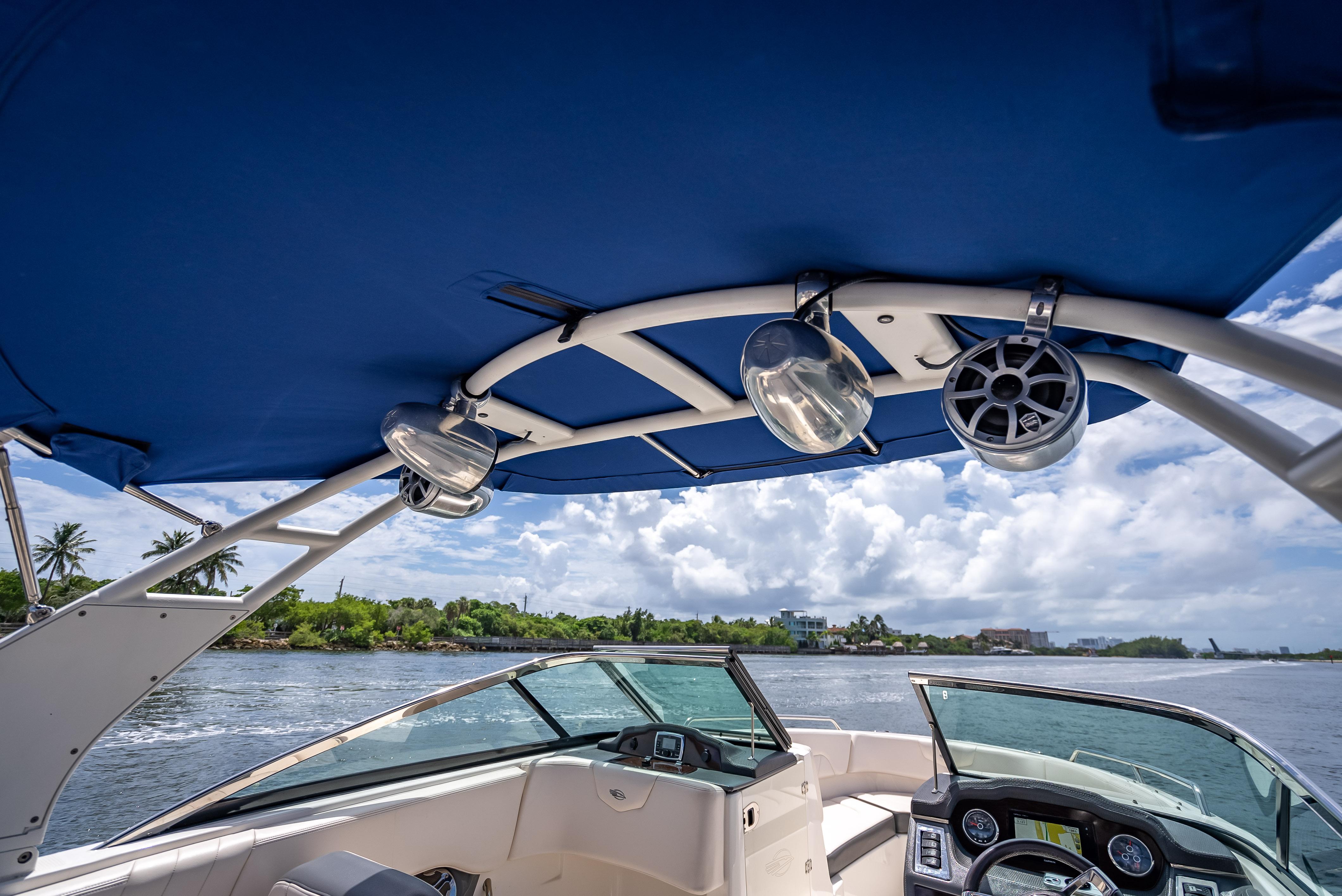2017 Chaparral 227 SSX boat interior with blue canopy and scenic water view.
