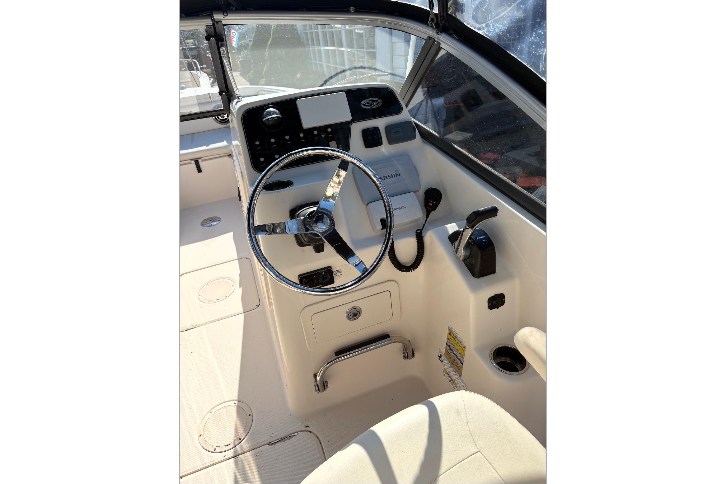 2015 Grady-White Freedom 225 boat cockpit with steering wheel and controls.