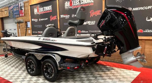 2025 Triton 20XP boat on display with powerful outboard motor.