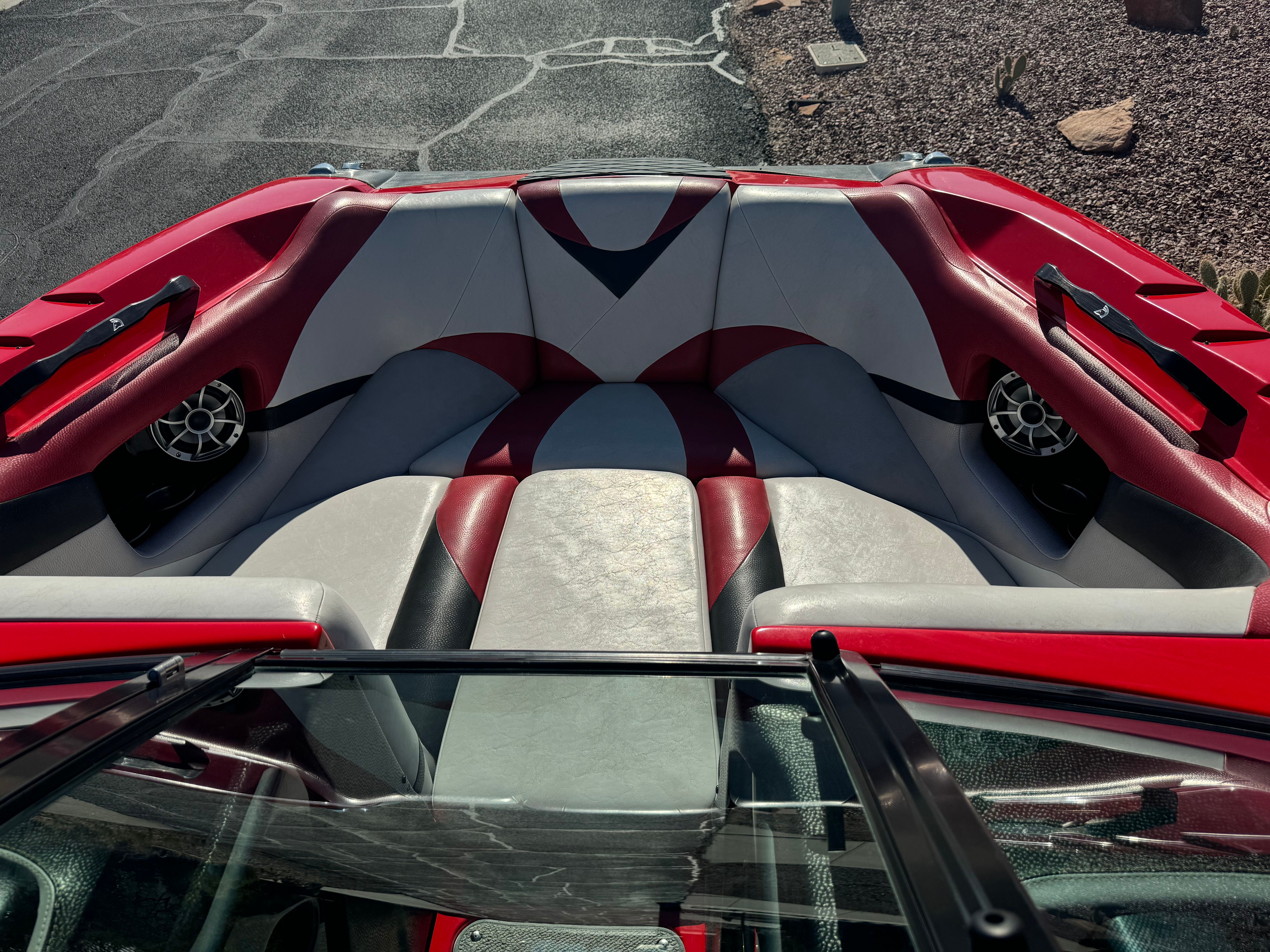 Interior of a 2014 Centurion Enzo FX44 boat with red and gray seating.