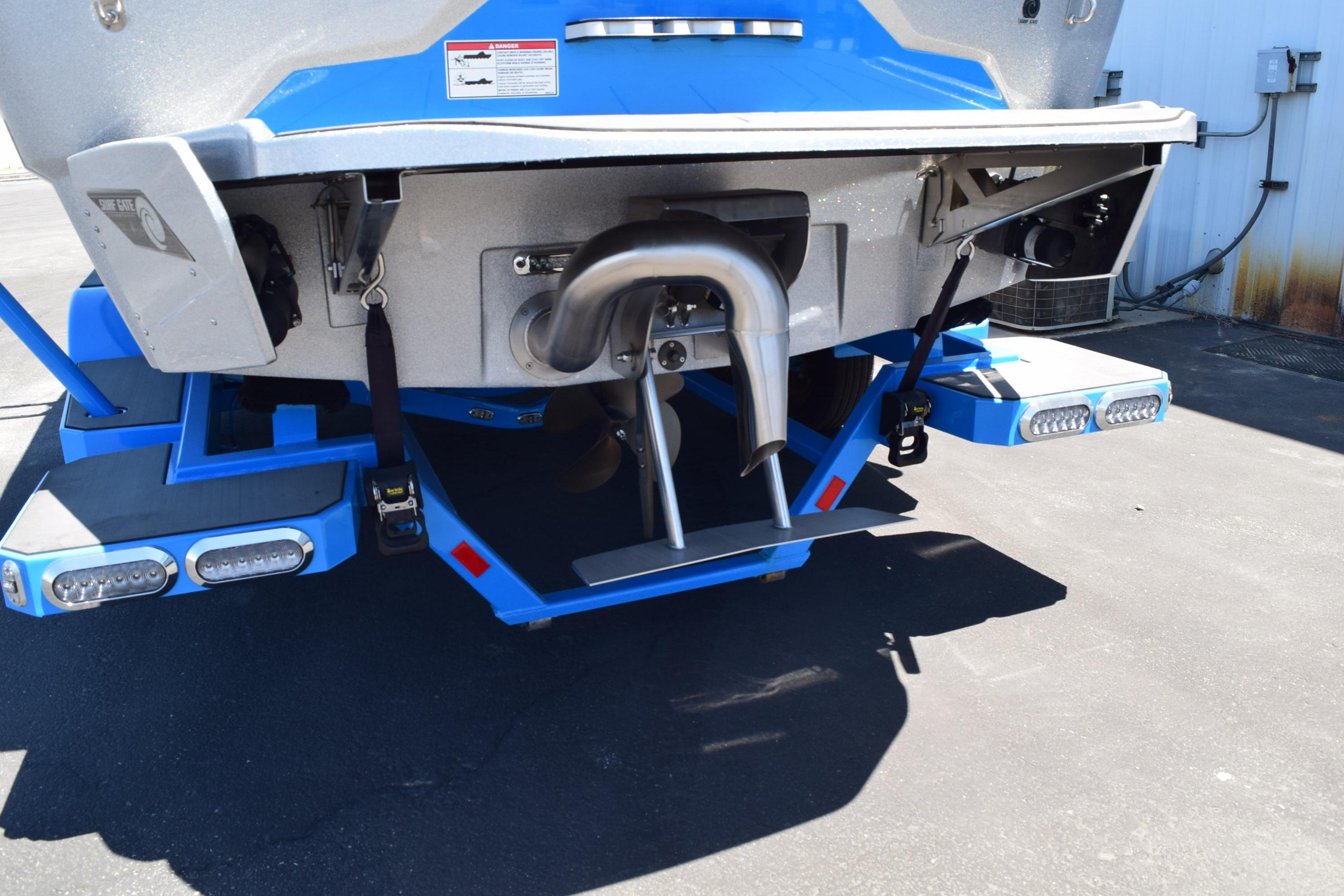 Rear view of a 2019 Axis A22 boat with surf gate and exhaust system.