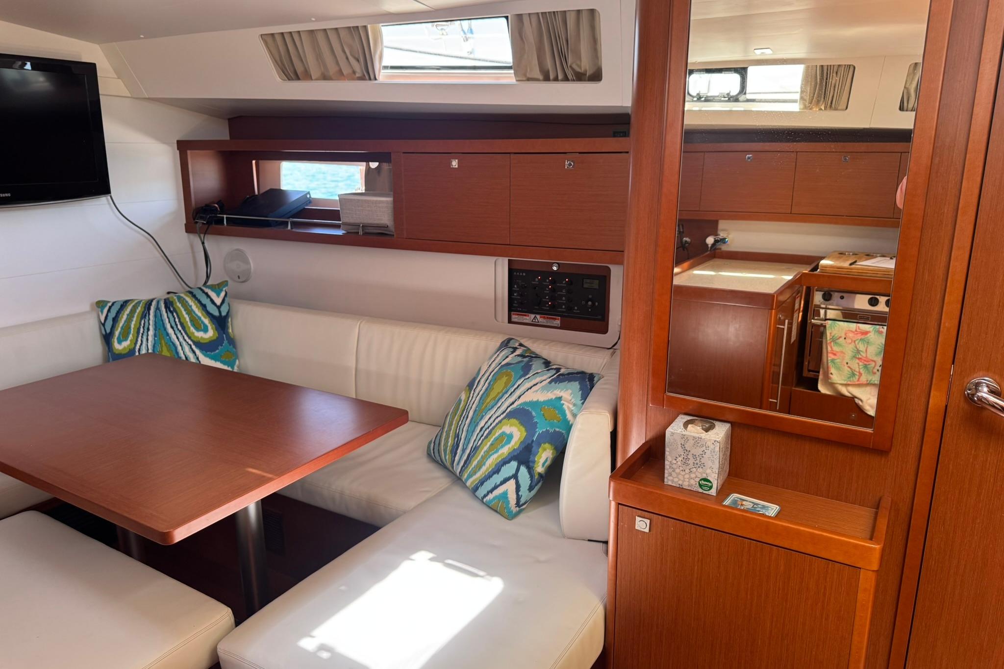 Interior of 2014 Beneteau Oceanis 45 yacht with cozy seating and modern amenities.