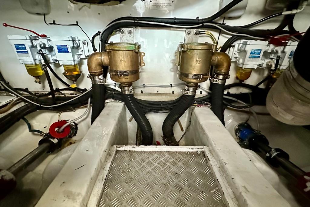 Engine room of 2005 Princess V58 yacht with visible fuel filters and piping.