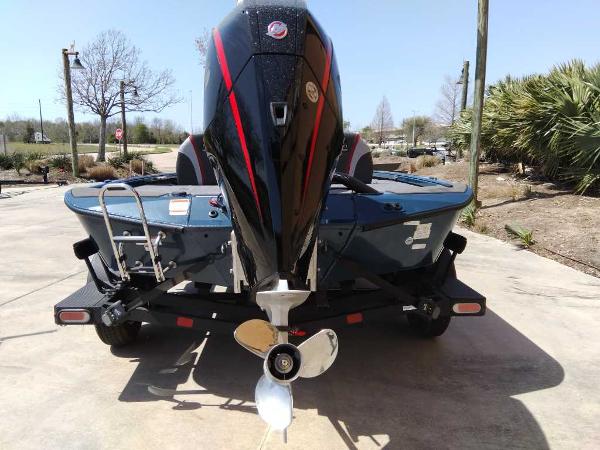 2025 Ranger ALPHA 208 boat with powerful outboard motor, parked on a sunny day.
