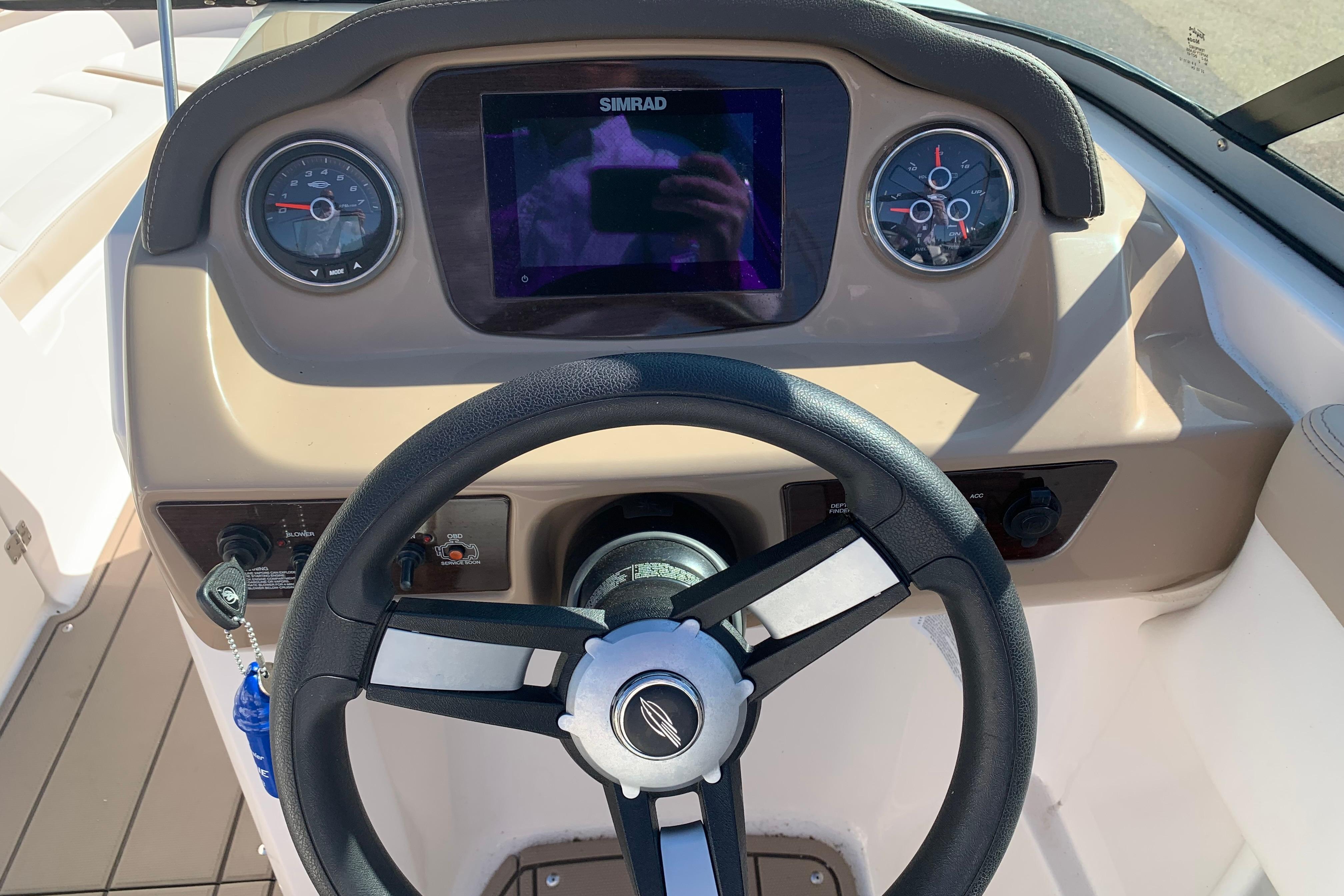 2022 Chaparral 23 SSi boat dashboard with steering wheel and Simrad display.