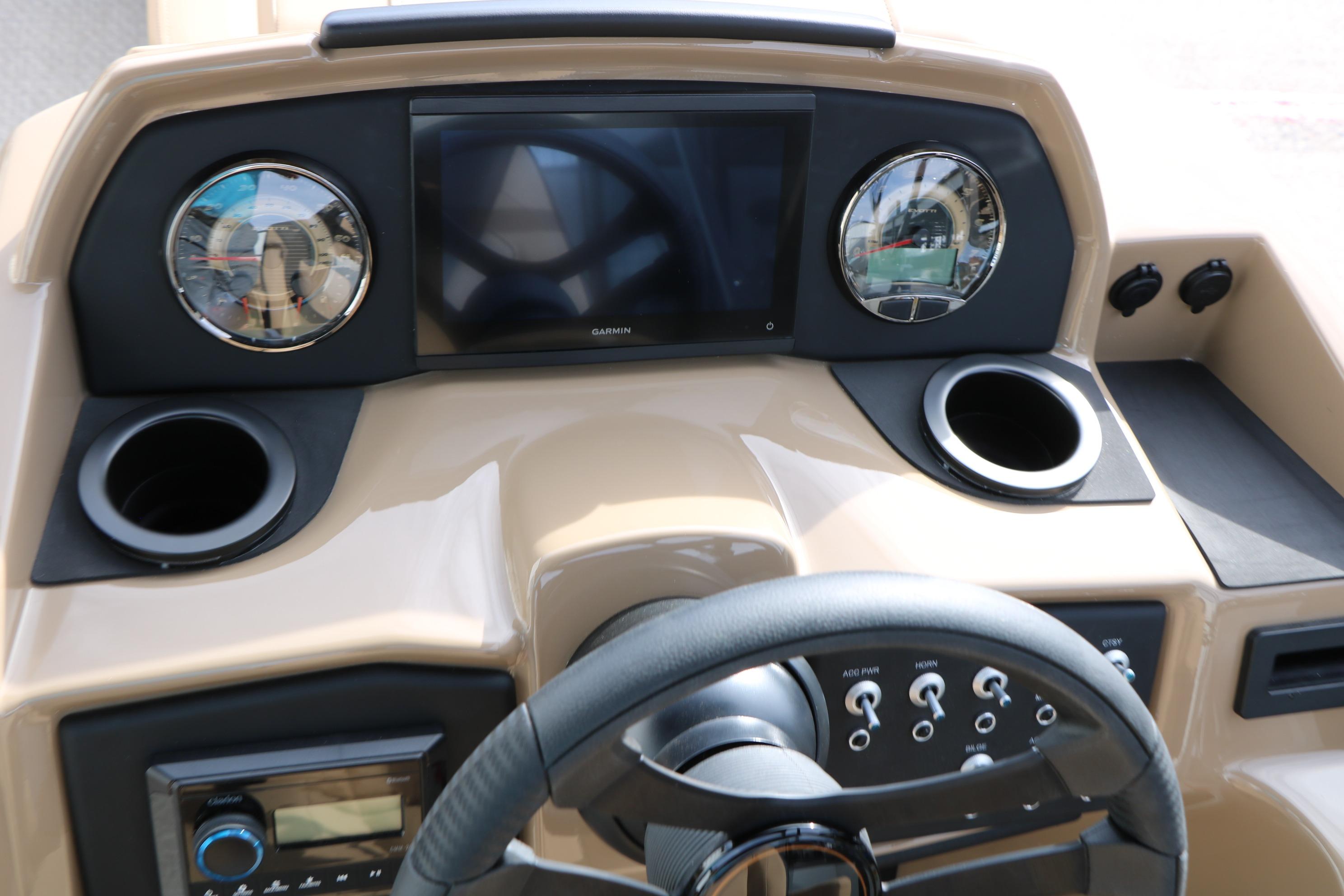 Dashboard of 2026 Evotti 523CS boat with steering wheel and digital display.