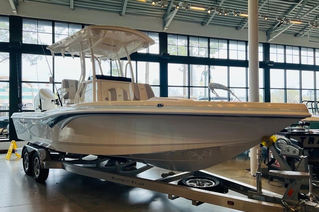 2024 Ranger 2600 Bay boat on trailer in showroom, featuring sleek design and modern amenities.