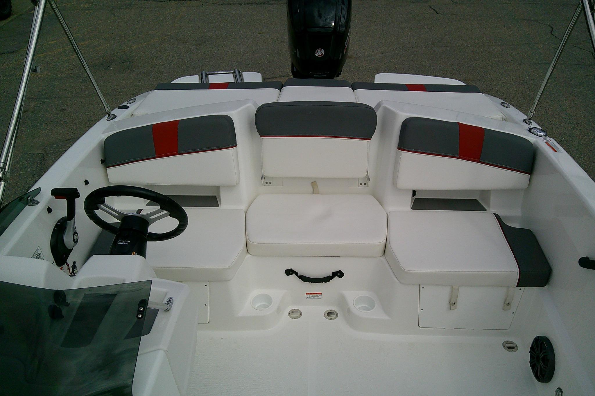 2024 Tahoe T18 boat interior with white and gray seating, steering wheel, and controls.