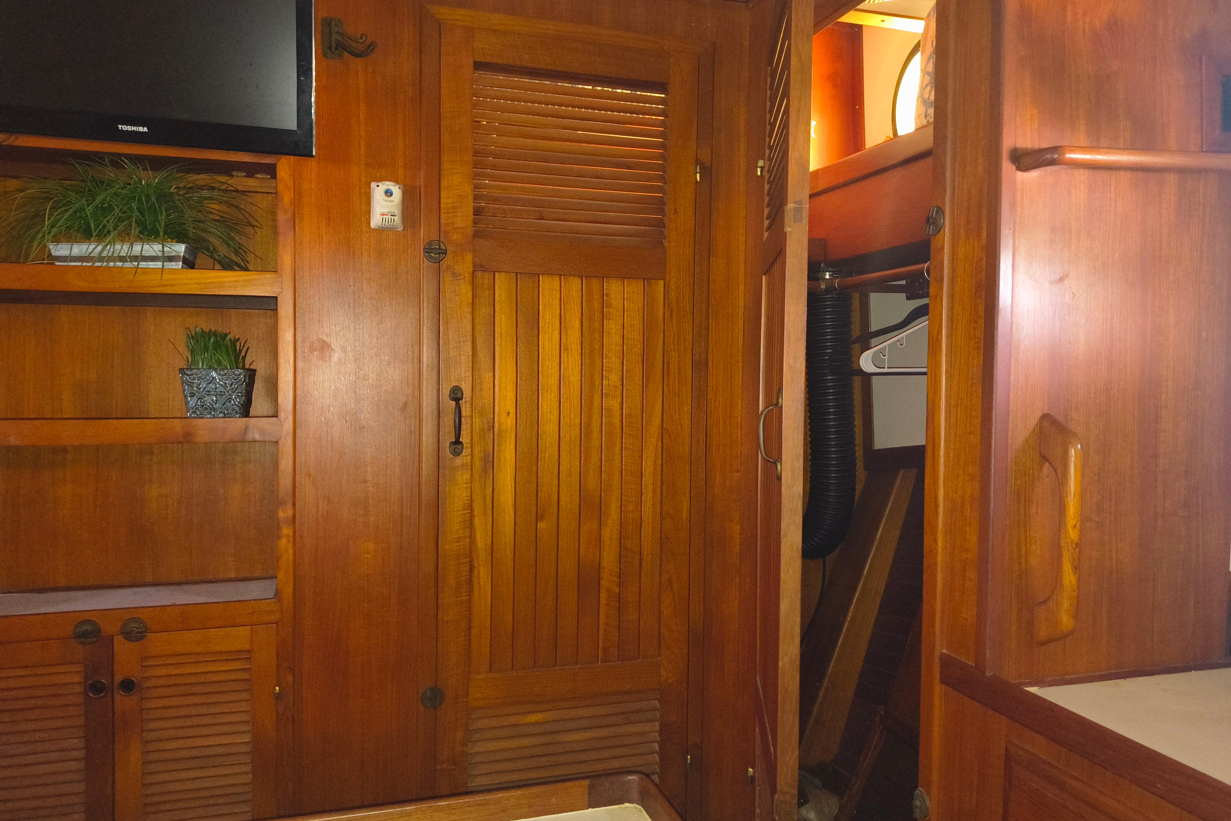 1984 Kadey-Krogen Manatee interior with wooden cabinetry and modern TV setup.