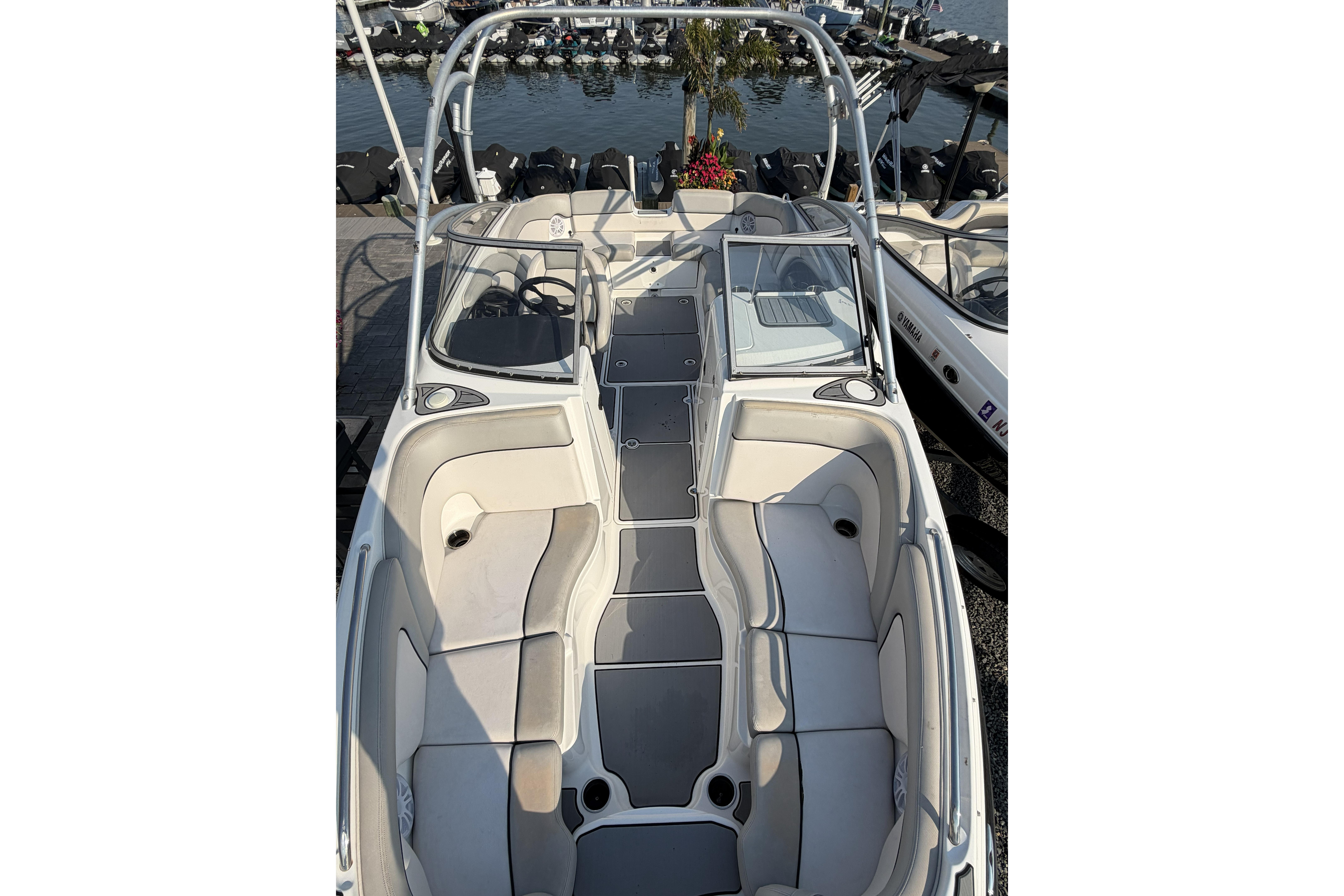 2011 Yamaha Boats AR240 HO interior view at marina, showcasing seating and helm.