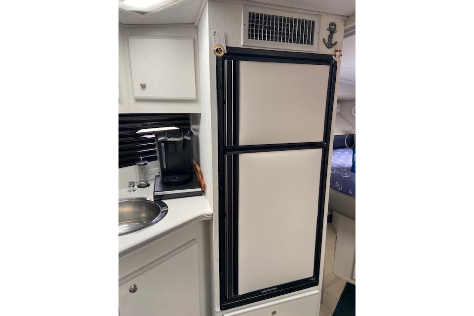 1994 Cruisers Yachts 3675 Esprit interior with kitchenette and refrigerator.