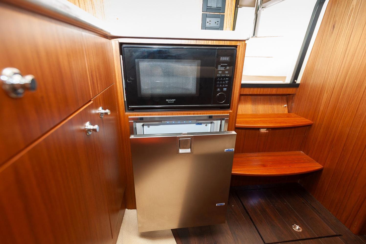 2014 Tiara Yachts 3100 Coronet interior with microwave and stainless steel fridge.