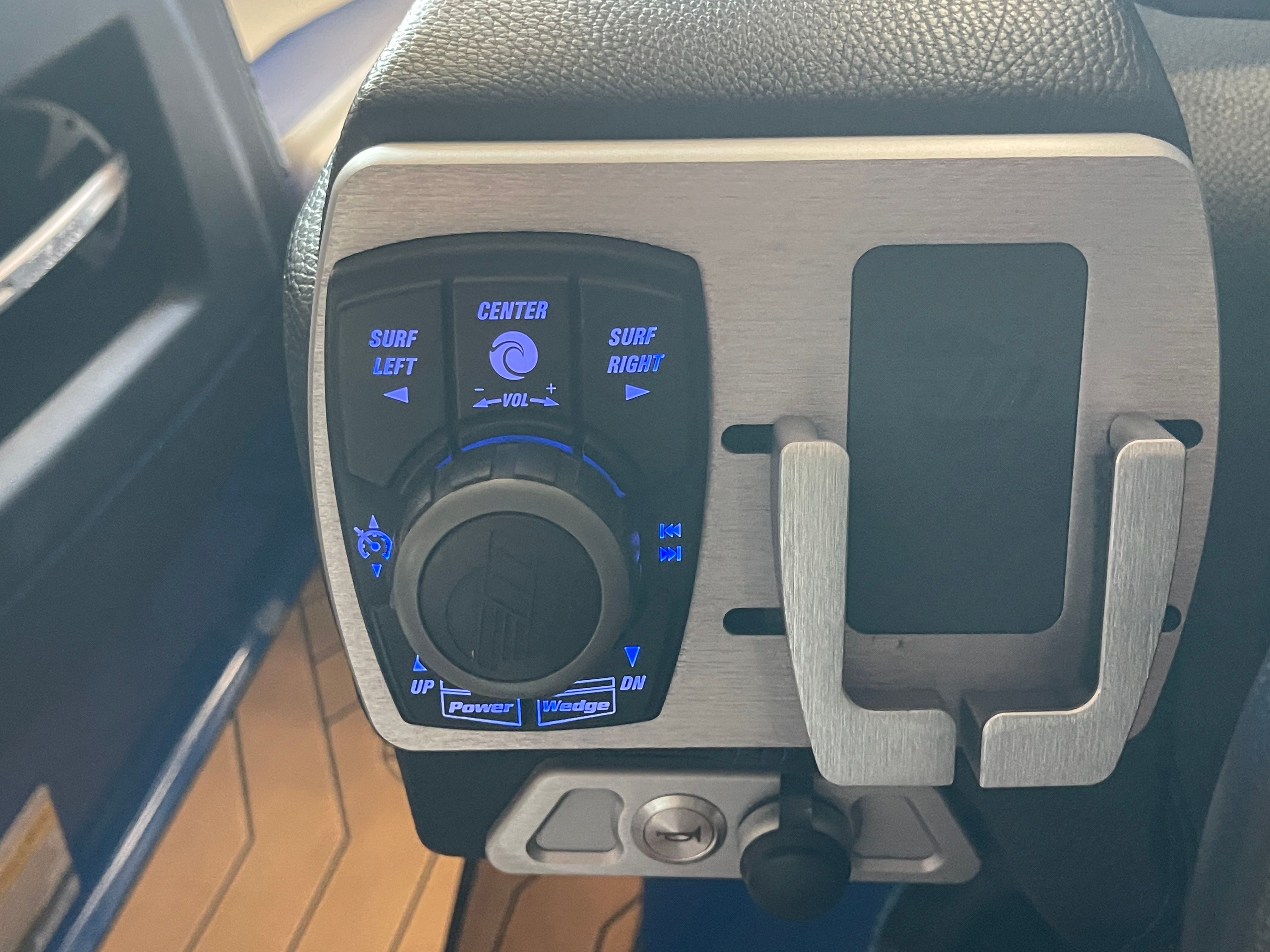 Close-up of a control panel with blue lighting on a boat.