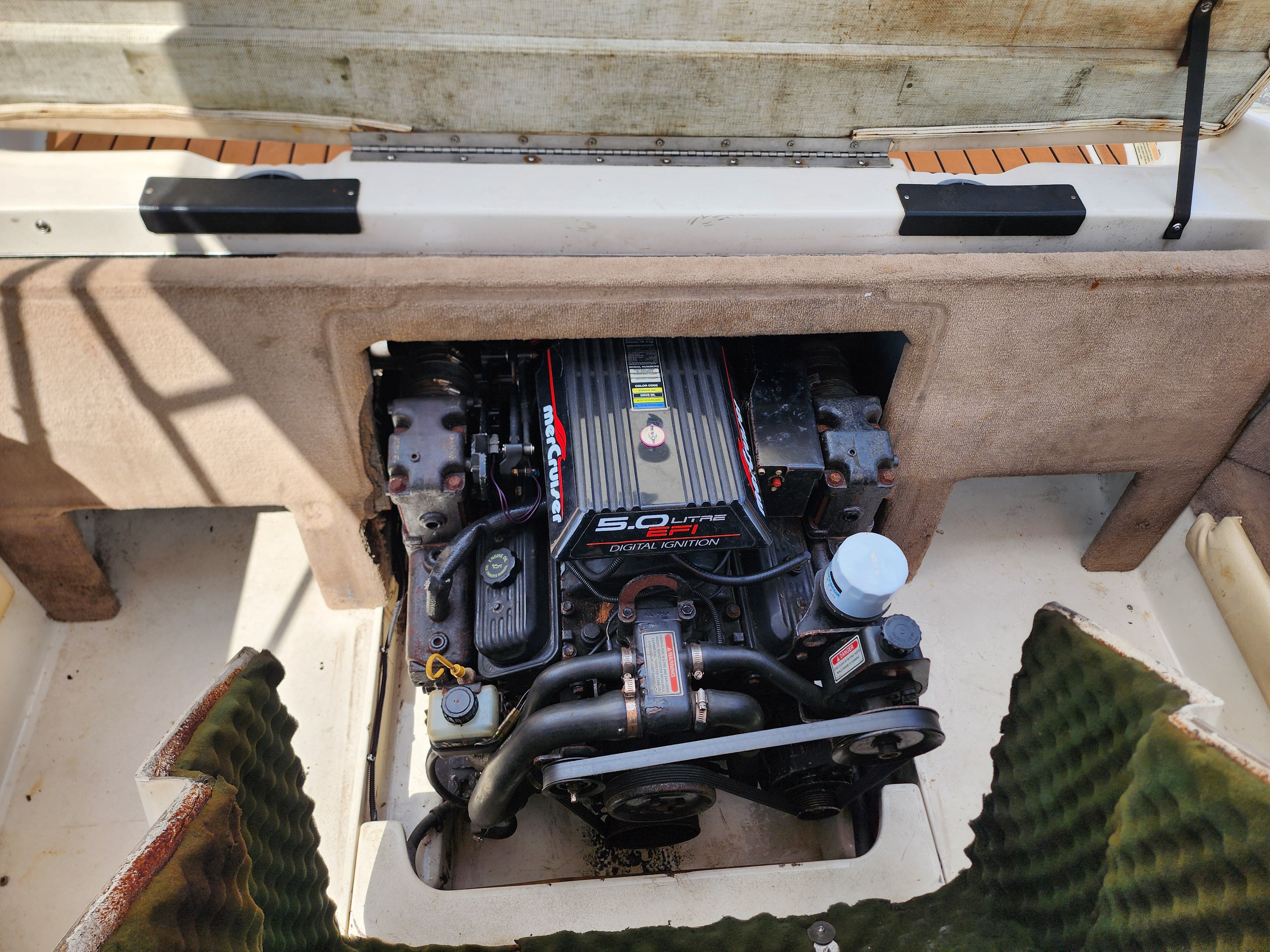 Engine compartment of a 1999 Sea Ray 210 Bowrider Signature with a 5.0 liter engine.