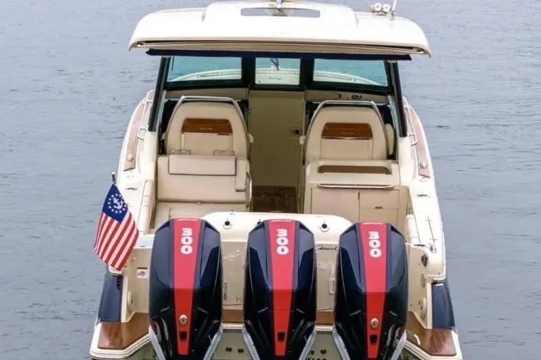 2023 Chris-Craft Calypso 35 boat with triple outboard engines on water.