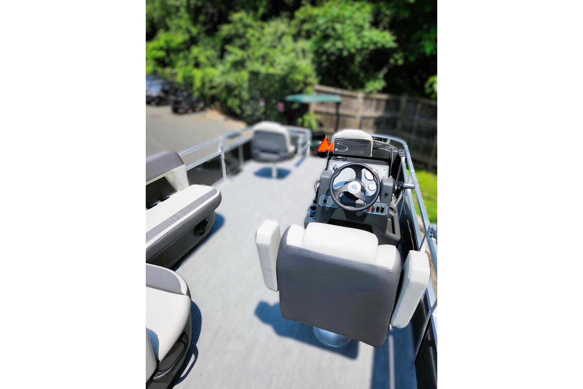 2026 Sun Tracker Bass Buggy 18 DLX pontoon boat interior with steering console.